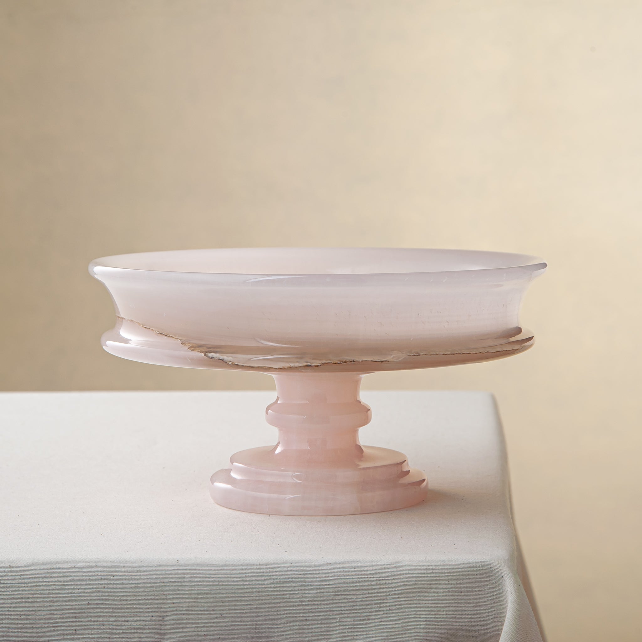 handcrafted onyx bowl with blush pink tones and translucent layered stone on pedestal for luxury decor
