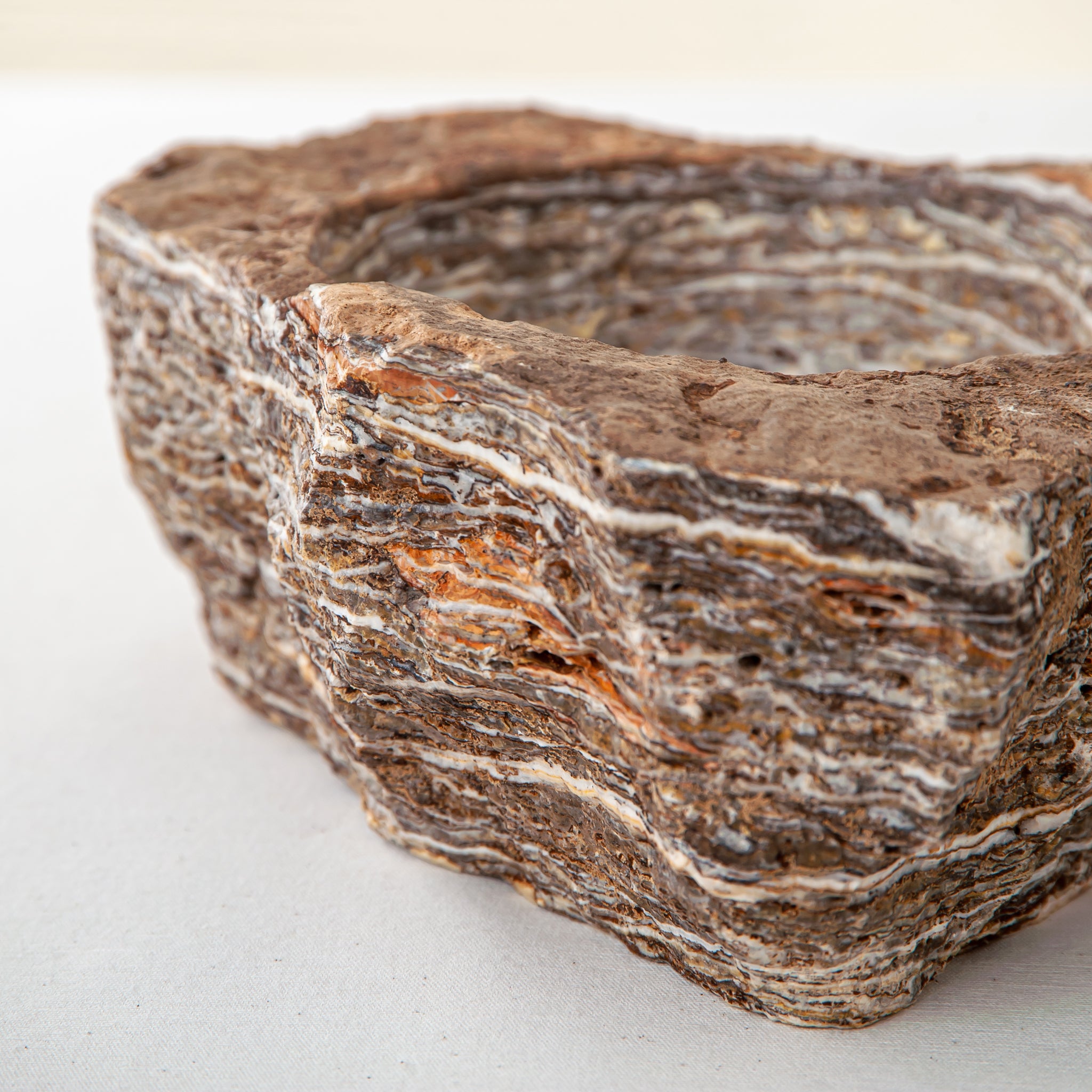 handcrafted onyx bowl with layered brown and ivory bands as sculptural centerpiece
