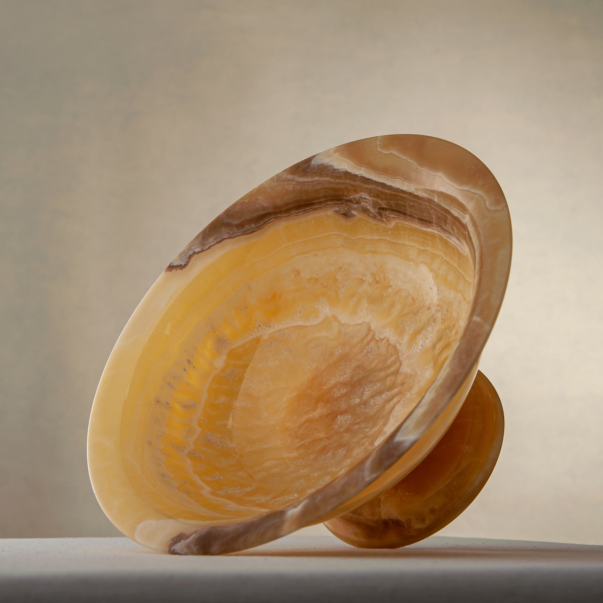 handcrafted onyx bowl with golden tones and caramel veining for luxury table decor
