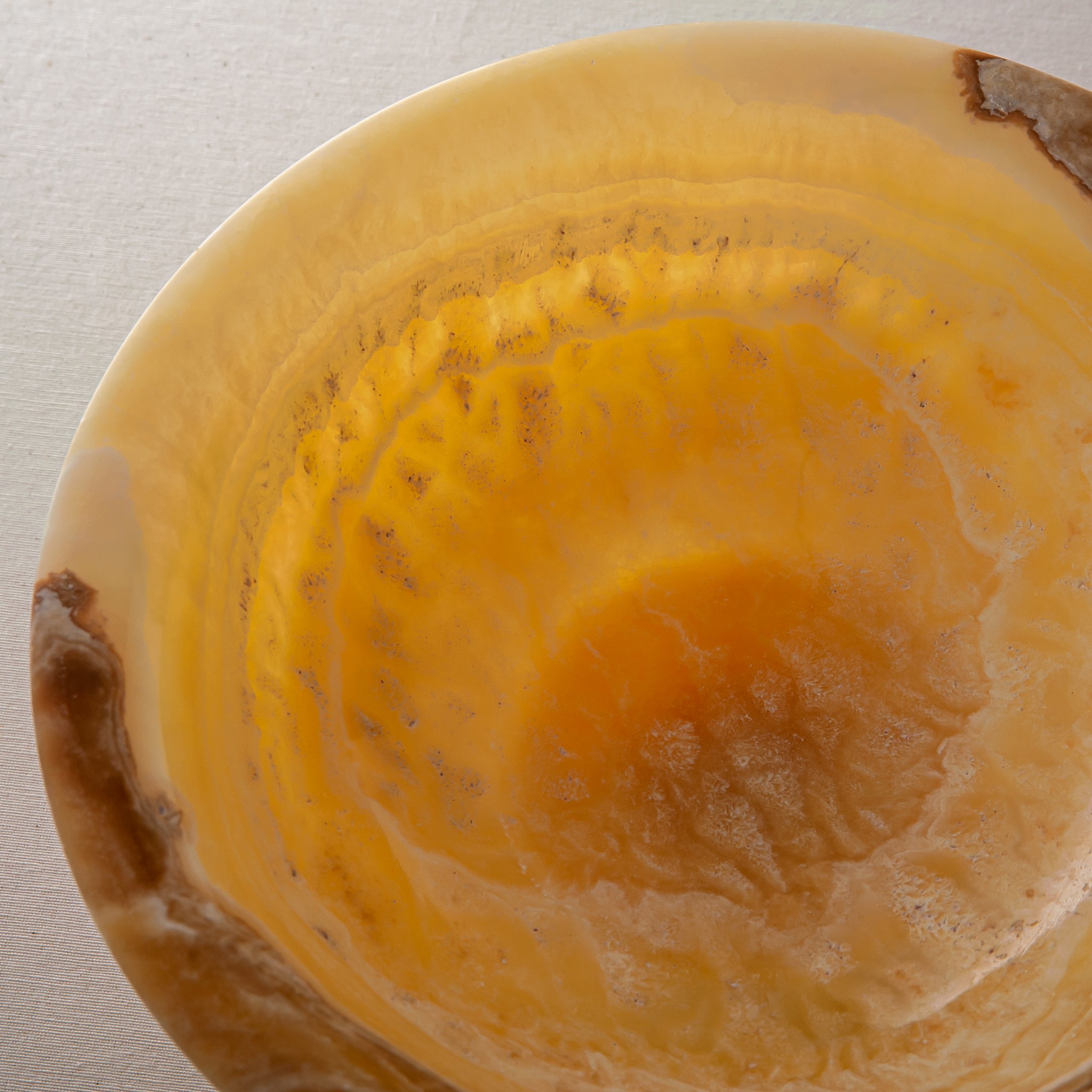 handcrafted onyx bowl with golden tones and caramel veining for luxury table decor

