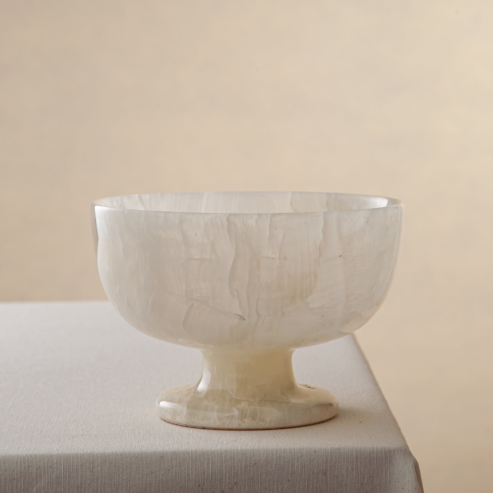 handcrafted alabaster pedestal bowl with translucent ivory stone and smooth polished surface
