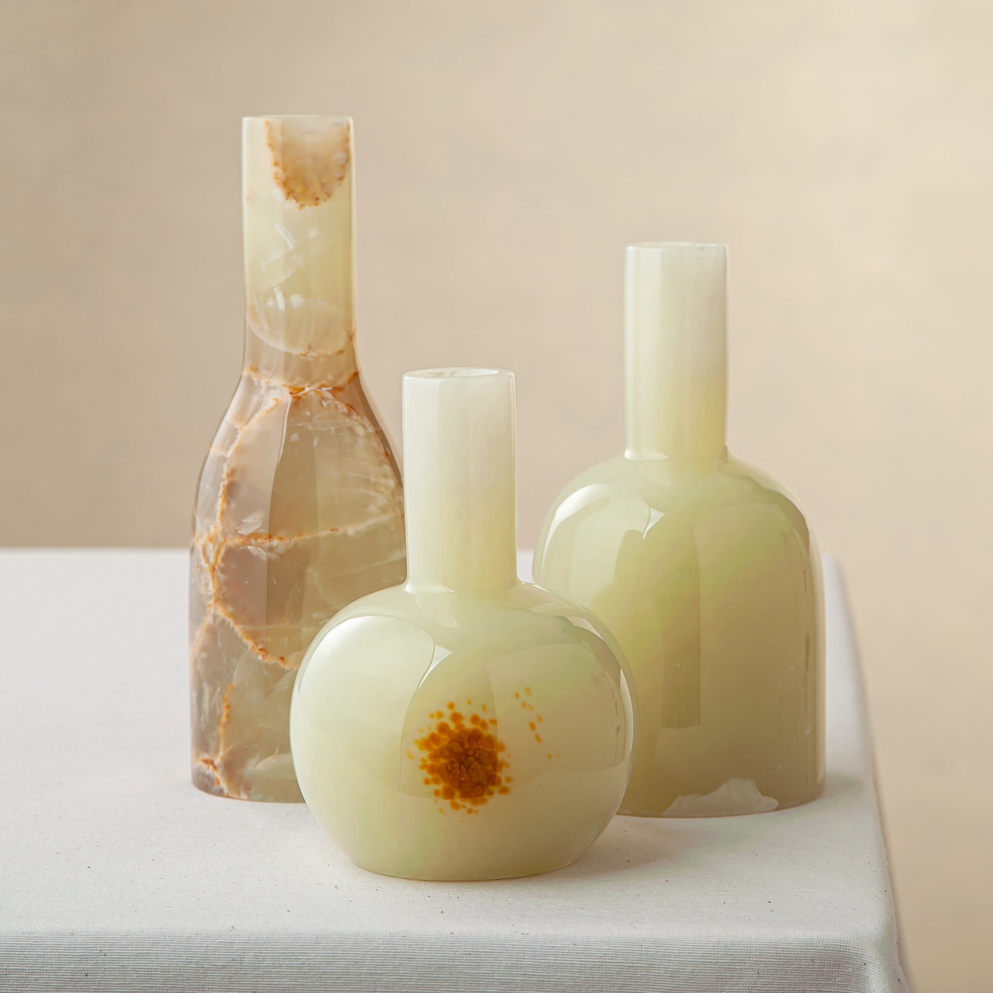 Unique handcrafted set of three light green onyx candle holders with translucent polished finish
