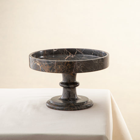 Handcrafted marble bowl with dark tones and warm veining also usable as elegant cake stand

