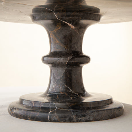 Handcrafted marble bowl with dark tones and warm veining also usable as elegant cake stand
