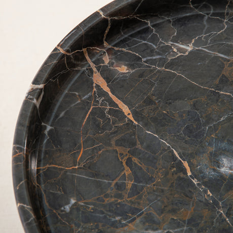 Handcrafted marble bowl with dark tones and warm veining also usable as elegant cake stand
