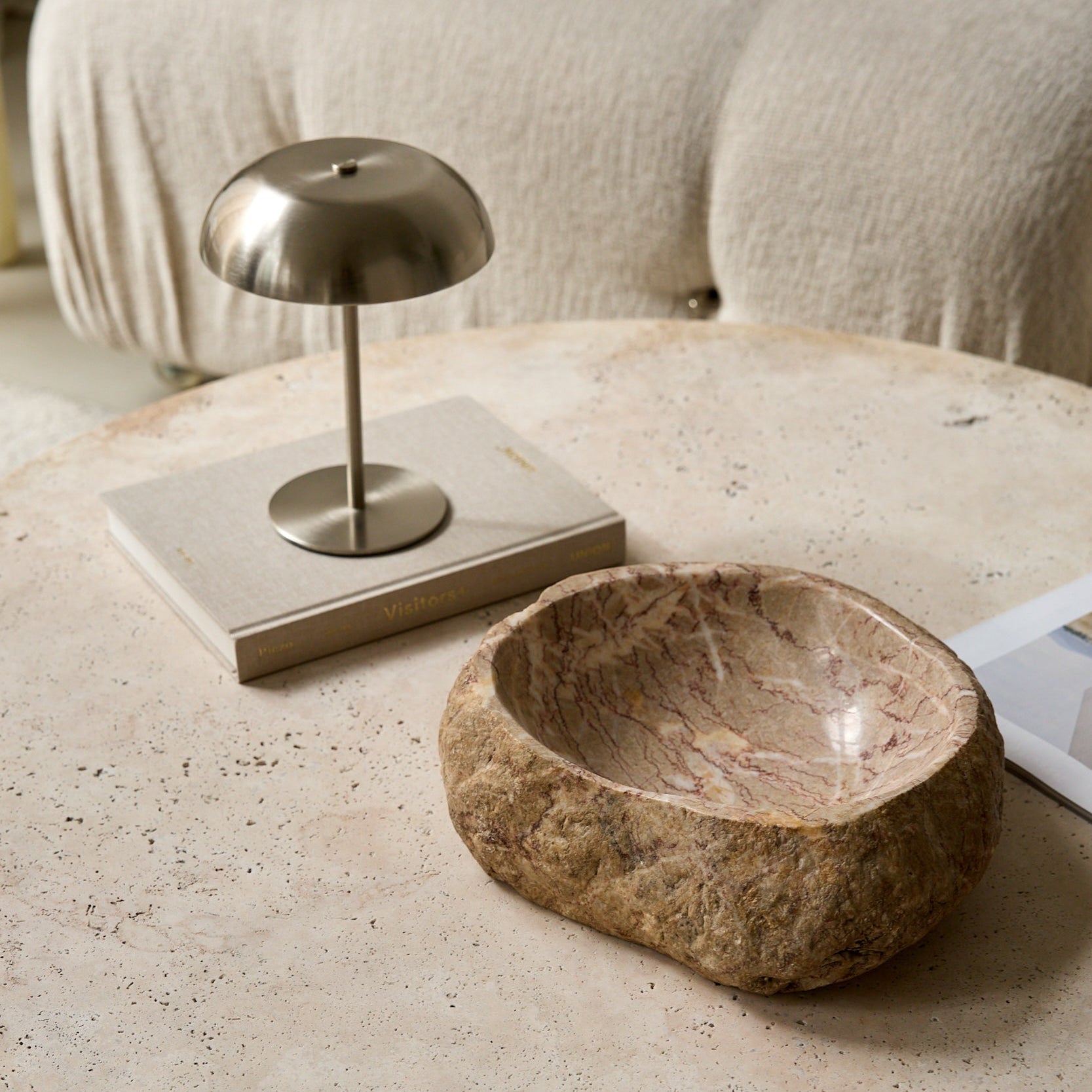 Unique handcrafted marble bowl with raw exterior and natural earthy veining
