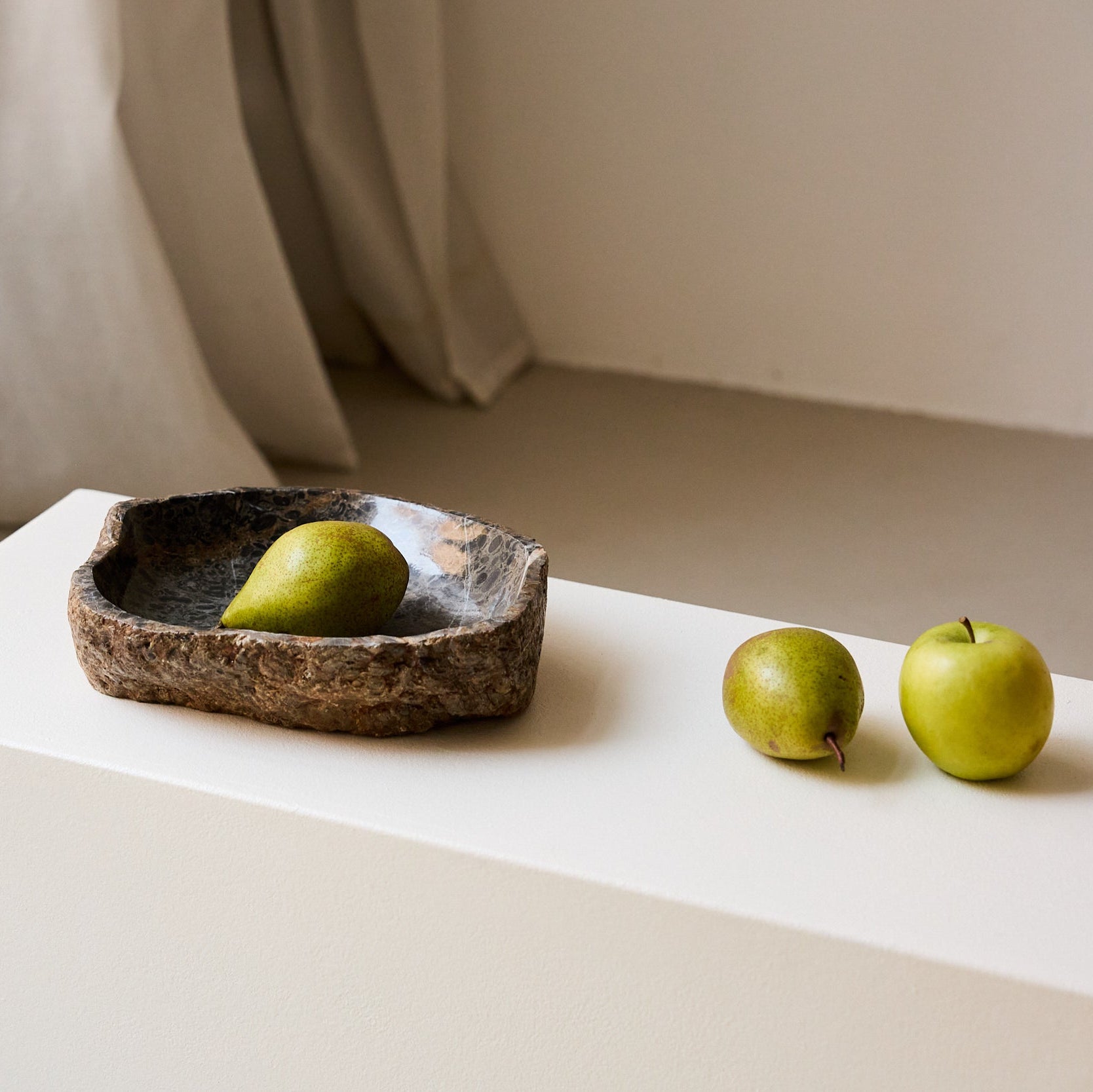 Unique marble bowl with raw textured exterior and polished fossil patterned interior
