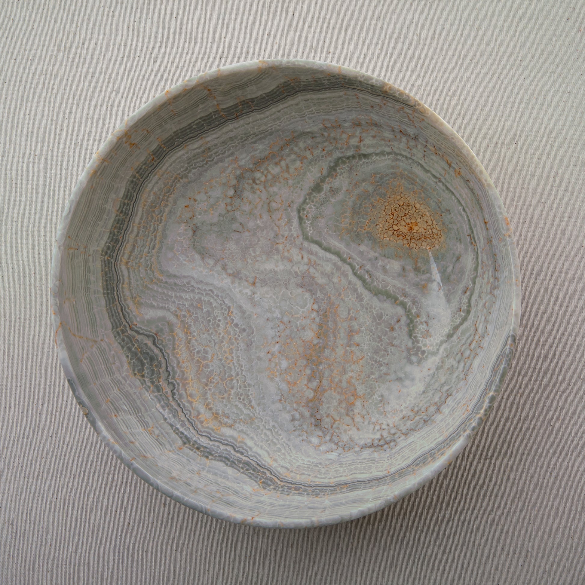 handcrafted marble bowl with sage green and grey banding and polished surface for elegant decor
