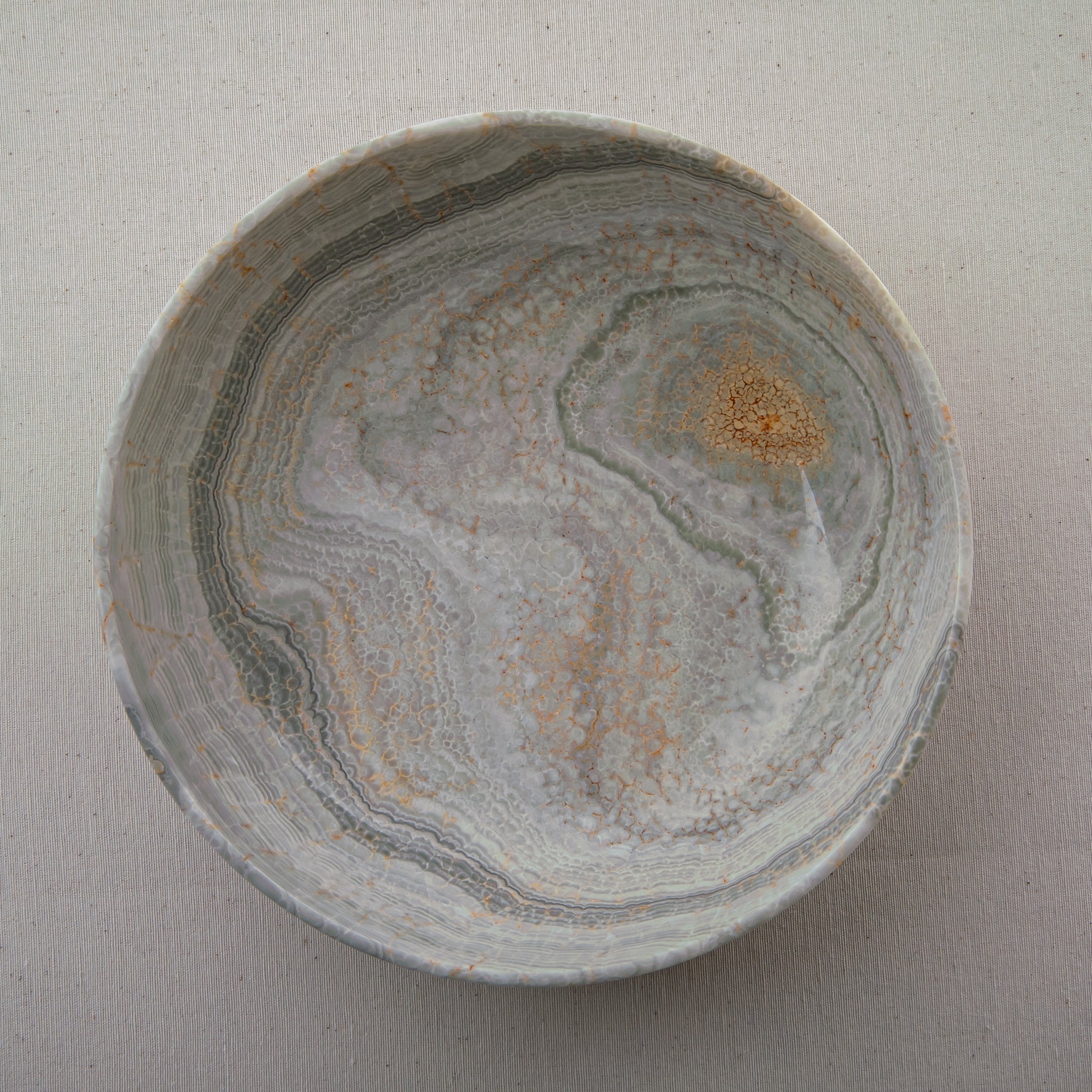 handcrafted marble bowl with sage green and grey banding and polished surface for elegant decor
