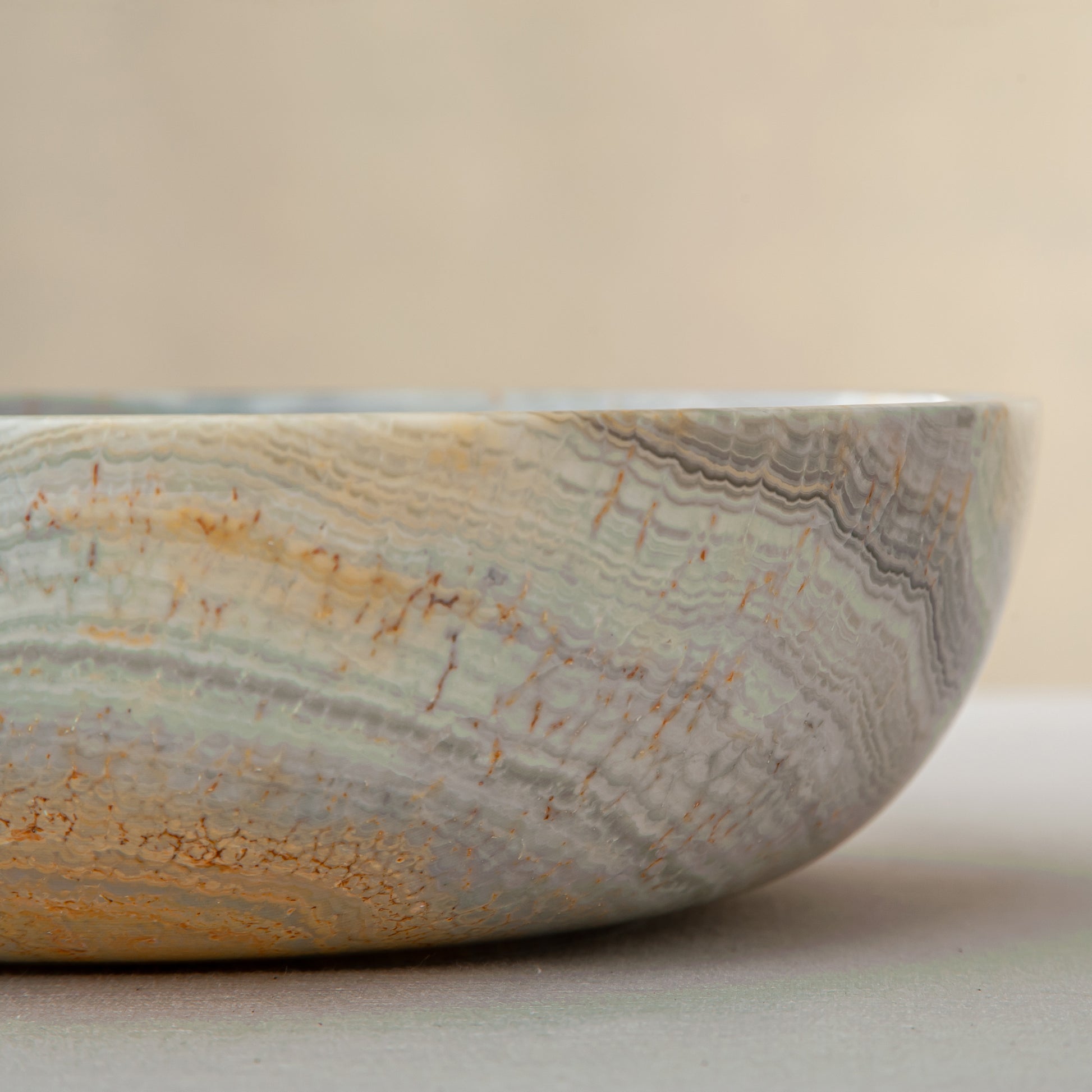 handcrafted marble bowl with sage green and grey banding and polished surface for elegant decor
