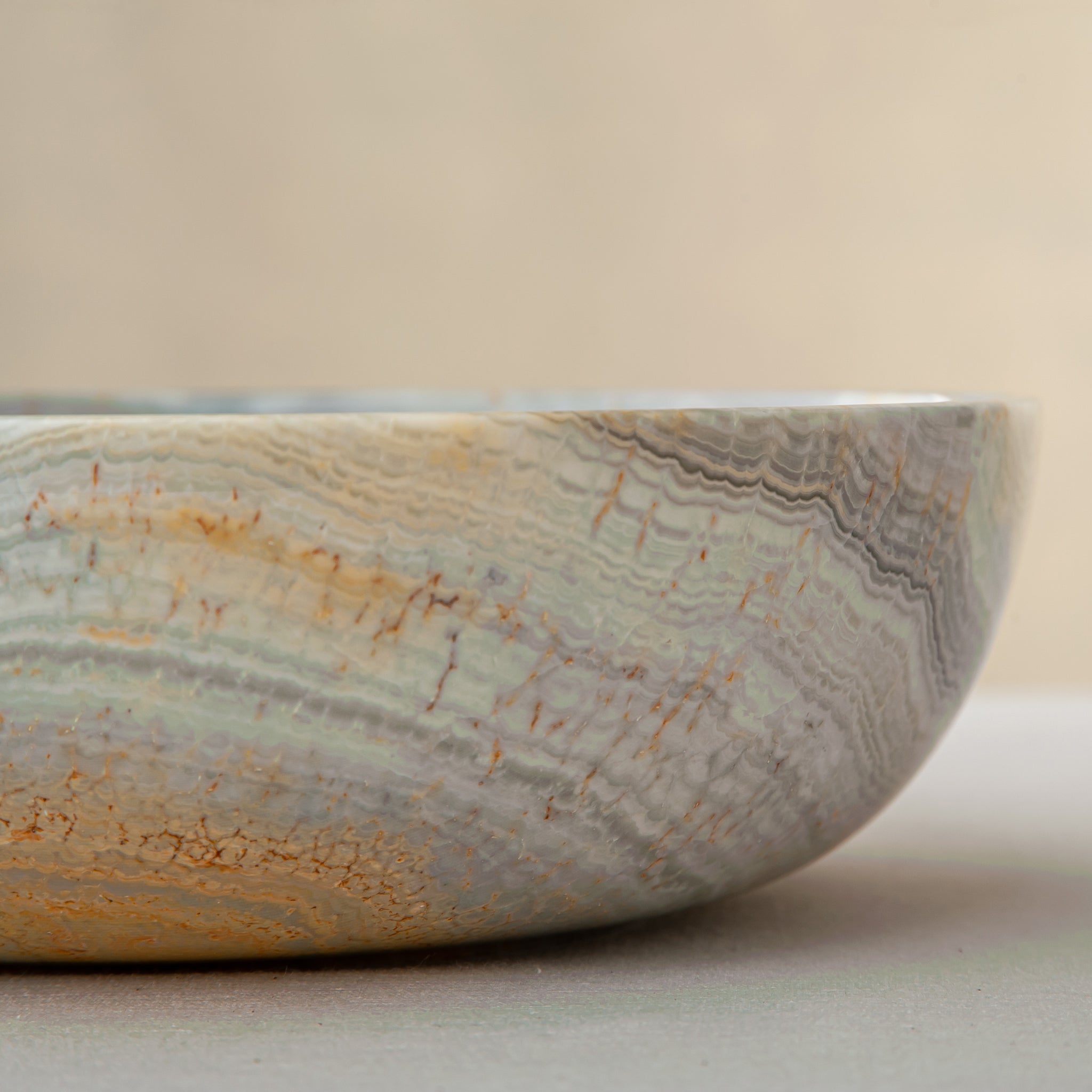 handcrafted marble bowl with sage green and grey banding and polished surface for elegant decor
