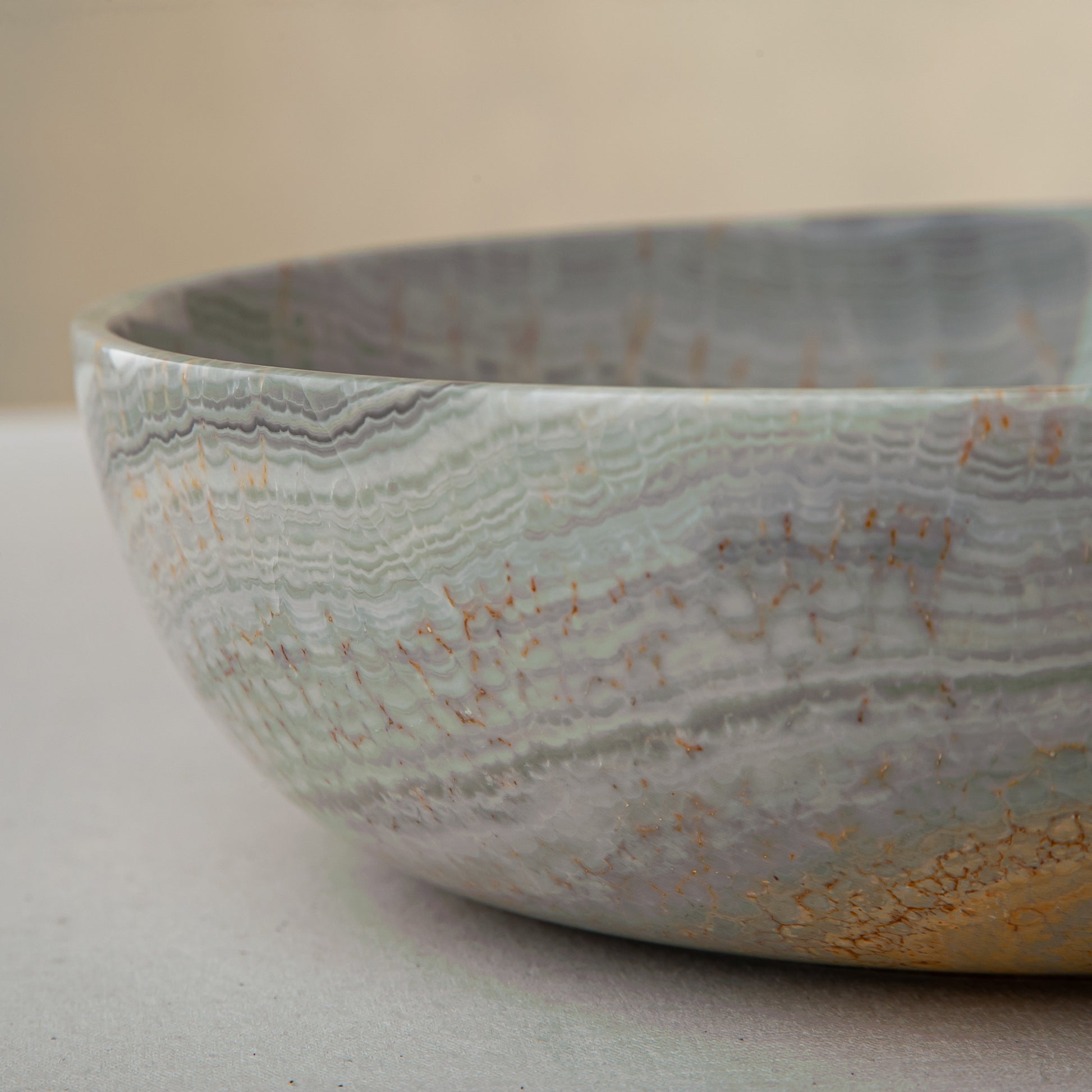 handcrafted marble bowl with sage green and grey banding and polished surface for elegant decor
