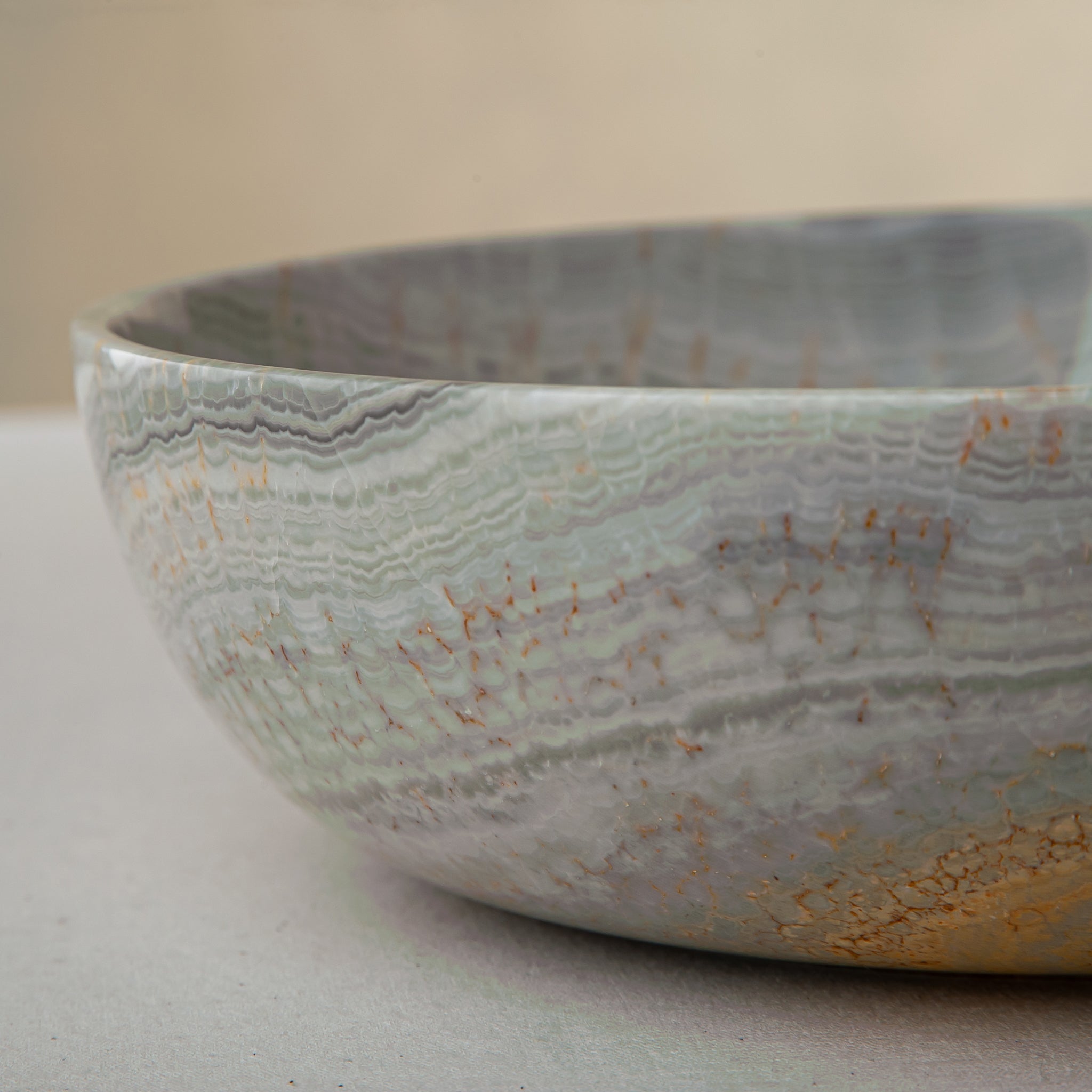 handcrafted marble bowl with sage green and grey banding and polished surface for elegant decor
