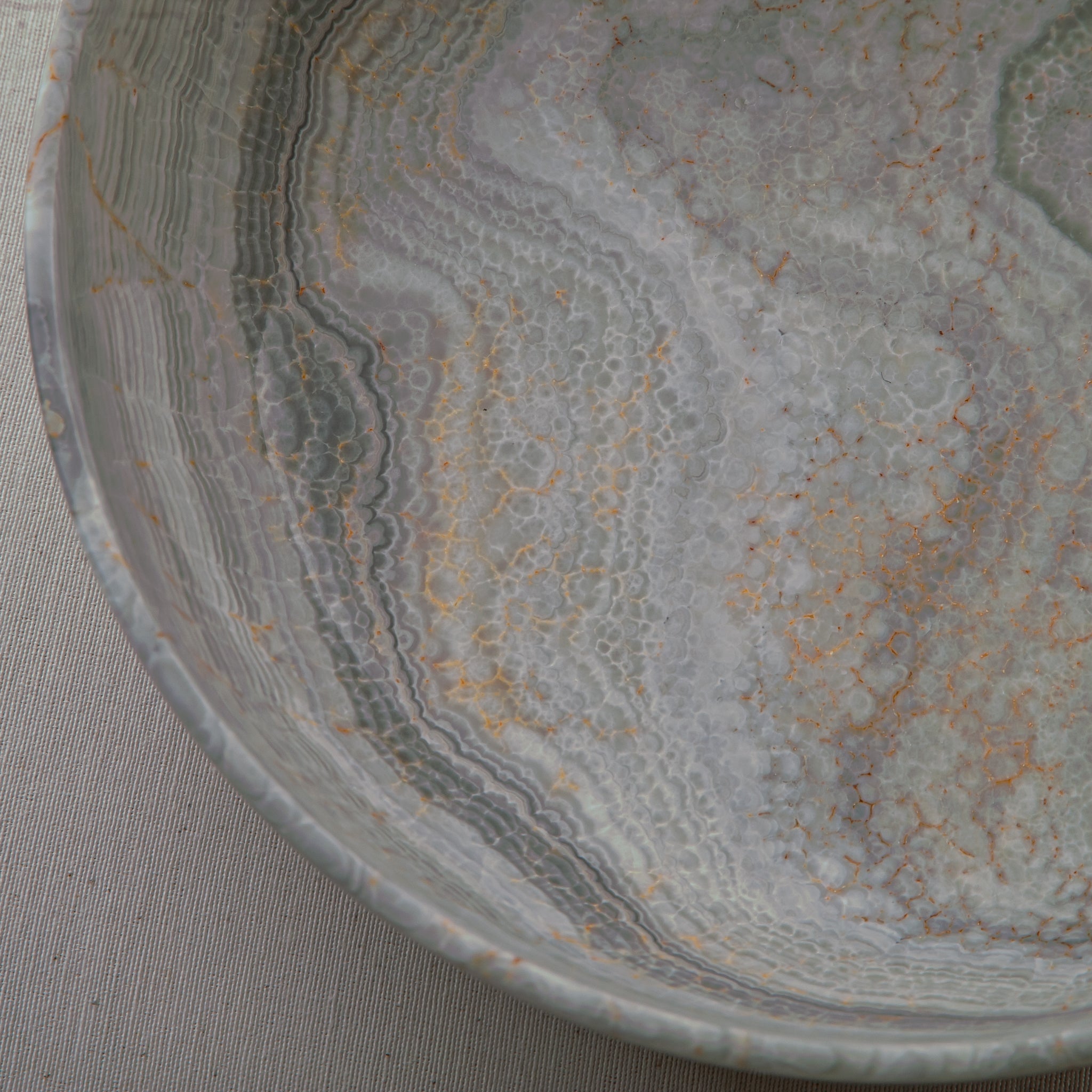 handcrafted marble bowl with sage green and grey banding and polished surface for elegant decor
