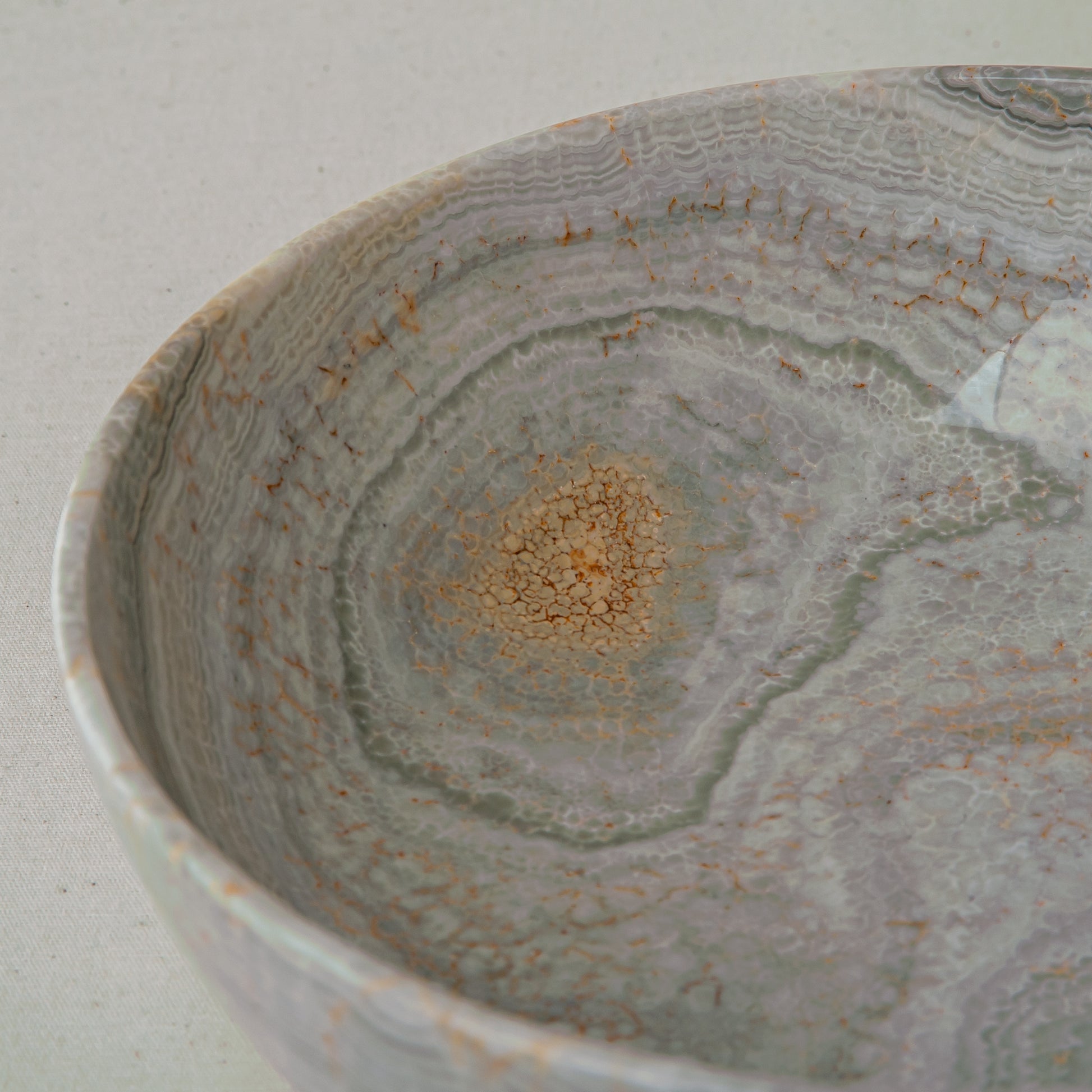 handcrafted marble bowl with sage green and grey banding and polished surface for elegant decor
