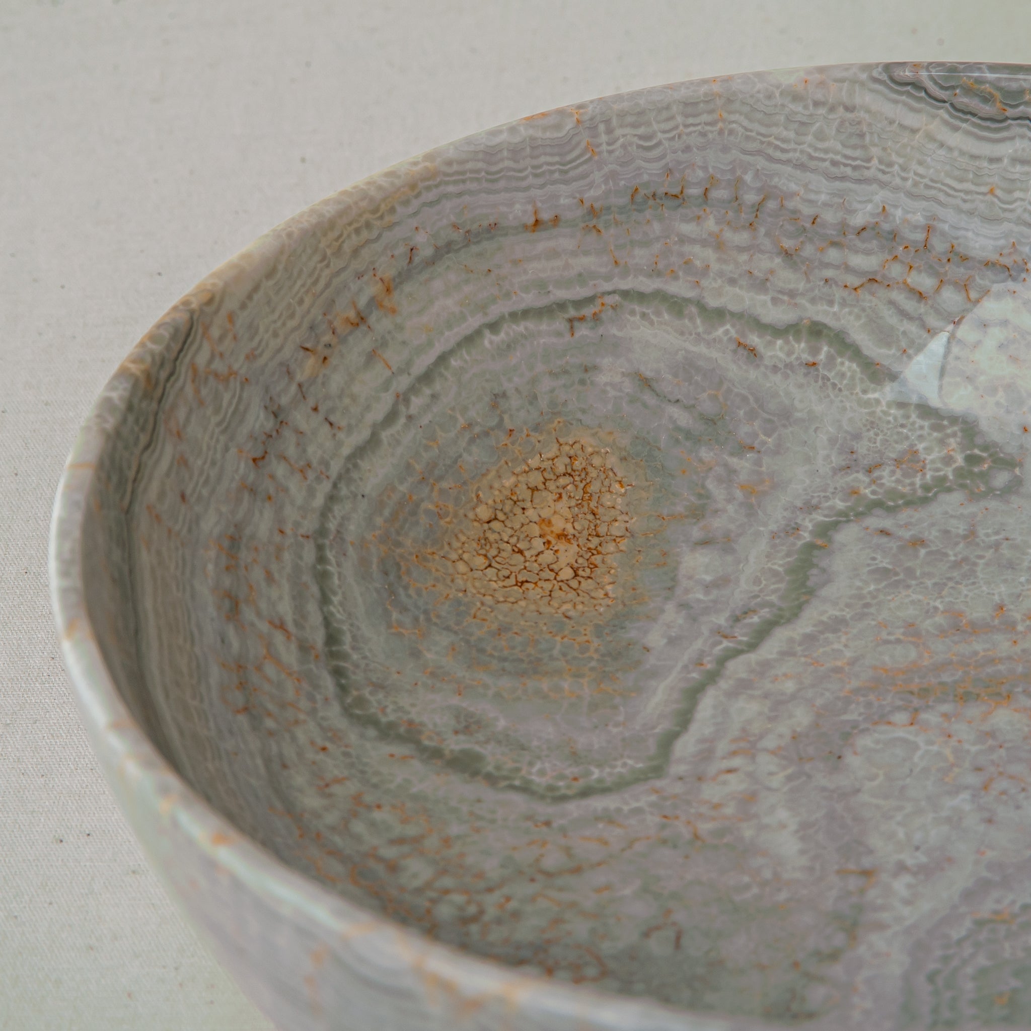 handcrafted marble bowl with sage green and grey banding and polished surface for elegant decor
