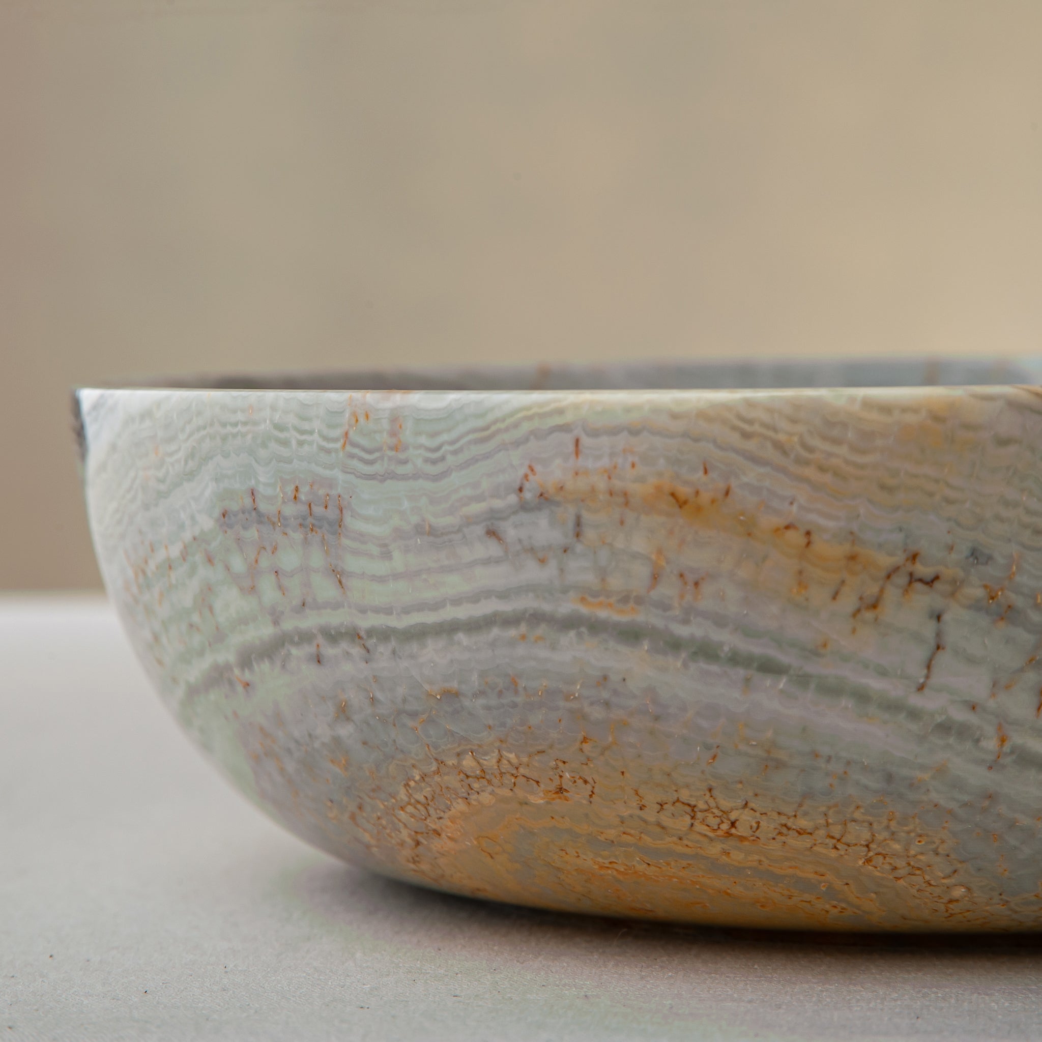handcrafted marble bowl with sage green and grey banding and polished surface for elegant decor
