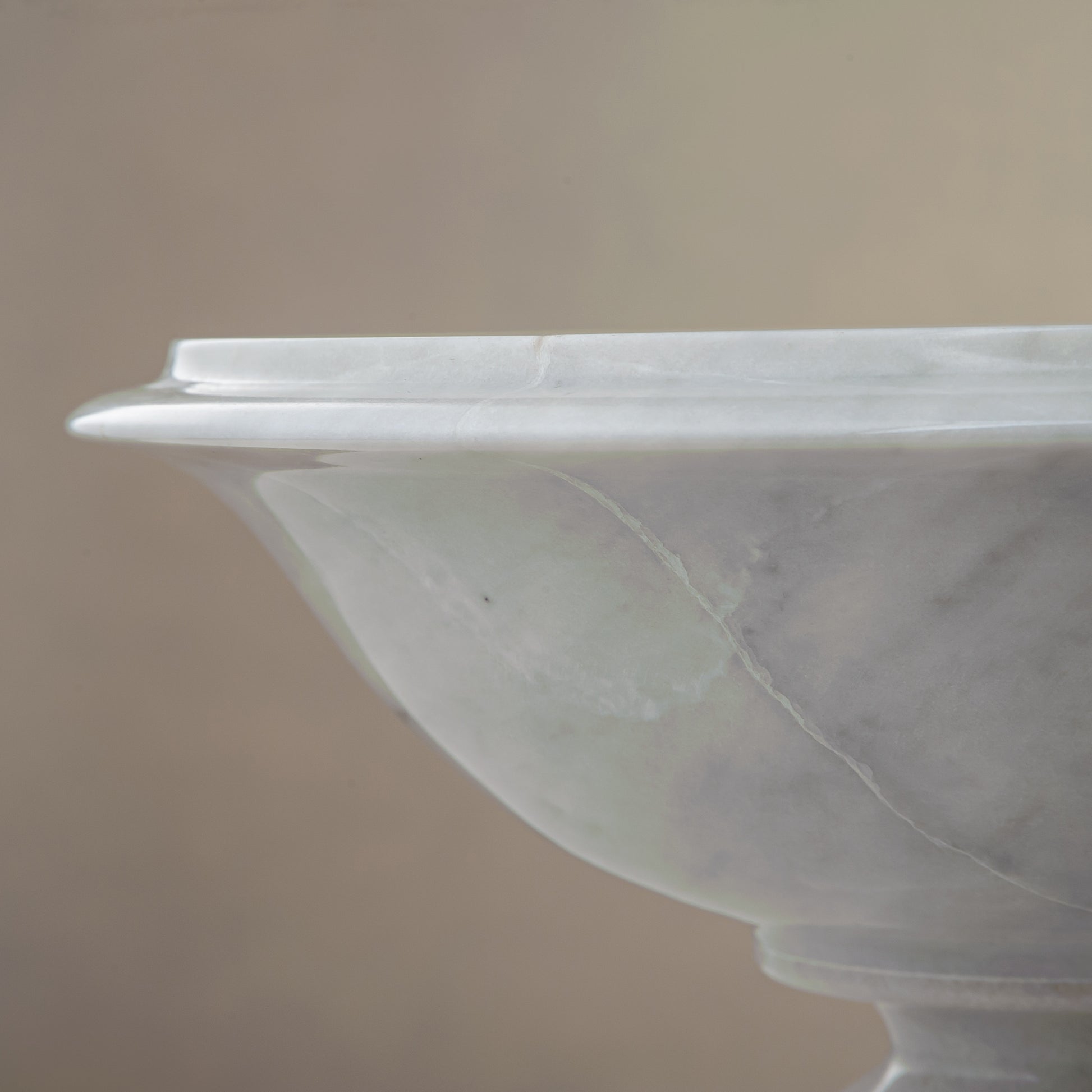 handcrafted marble bowl with white surface and subtle grey veining on pedestal for luxury decor
