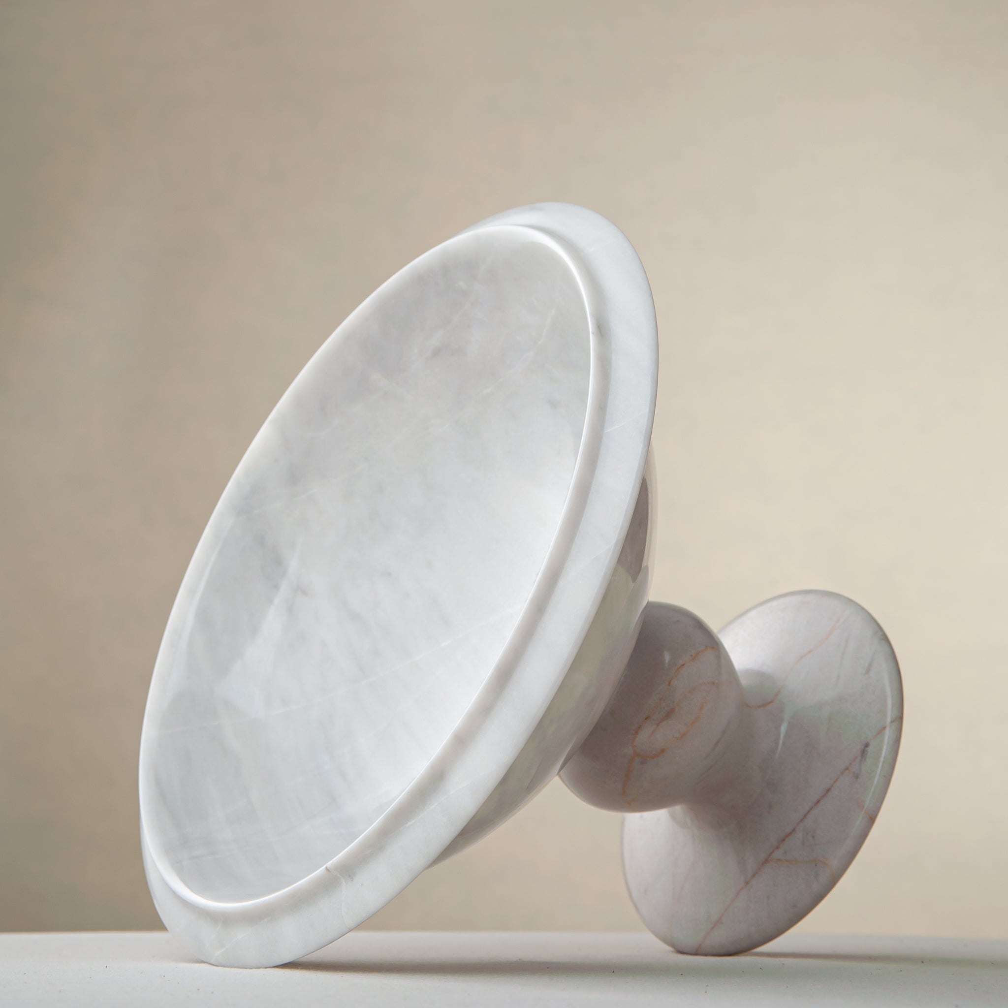 handcrafted marble bowl with white surface and subtle grey veining on pedestal for luxury decor
