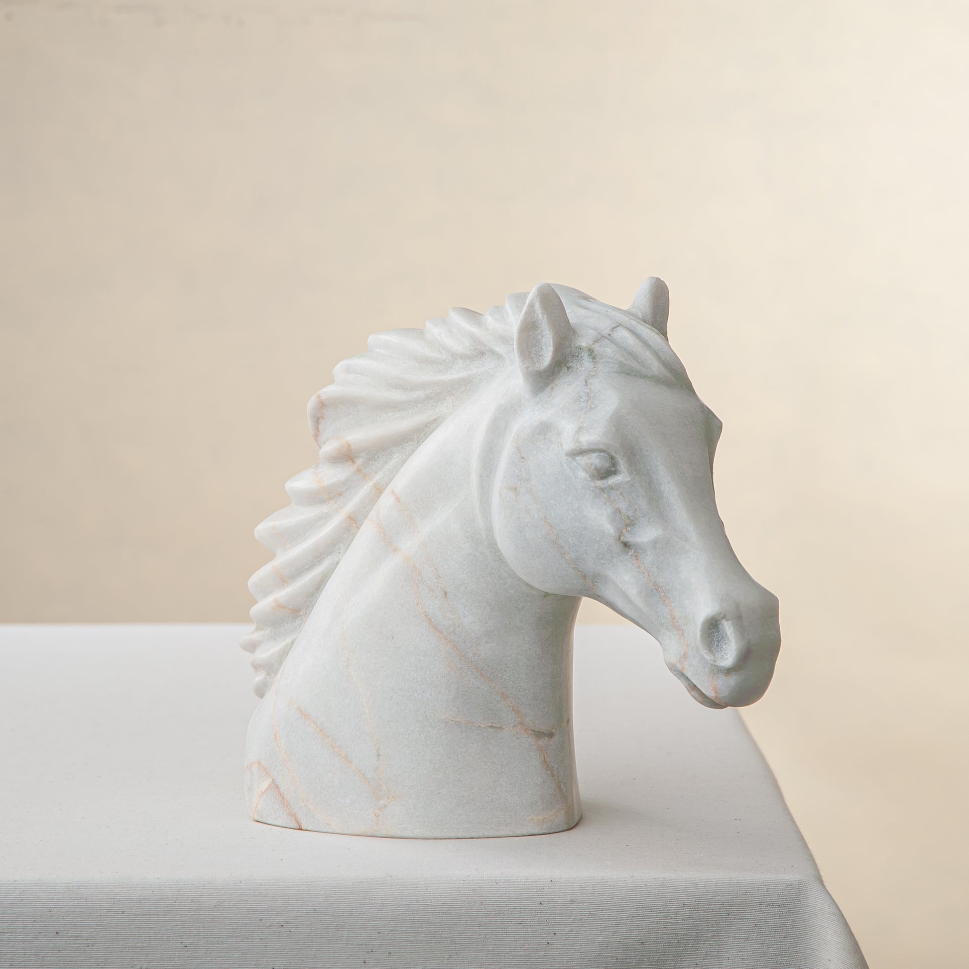 handcrafted marble horse sculpture with white stone and subtle warm veining for luxury decor
