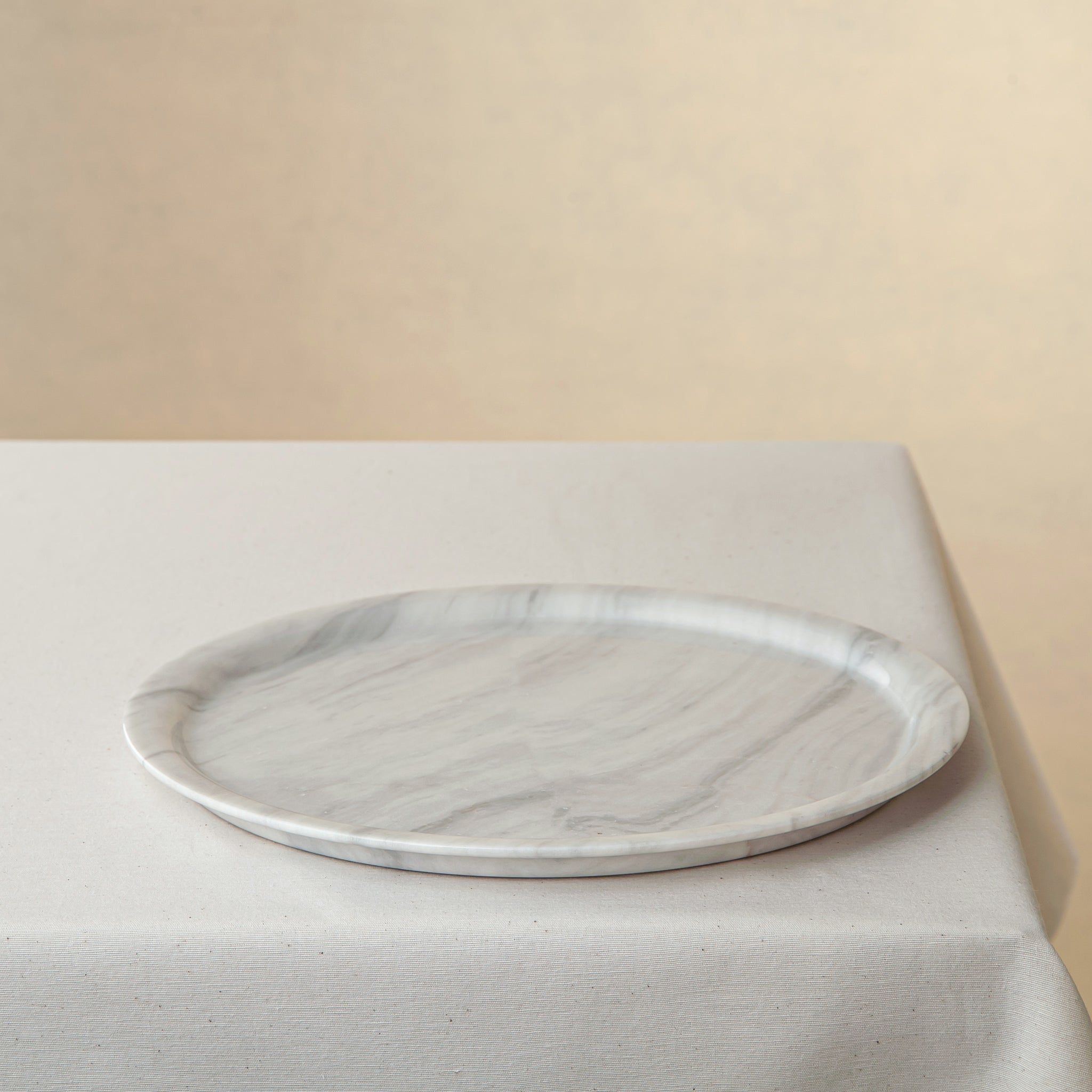 handcrafted marble plate with soft white surface and grey veining for elegant table decor
