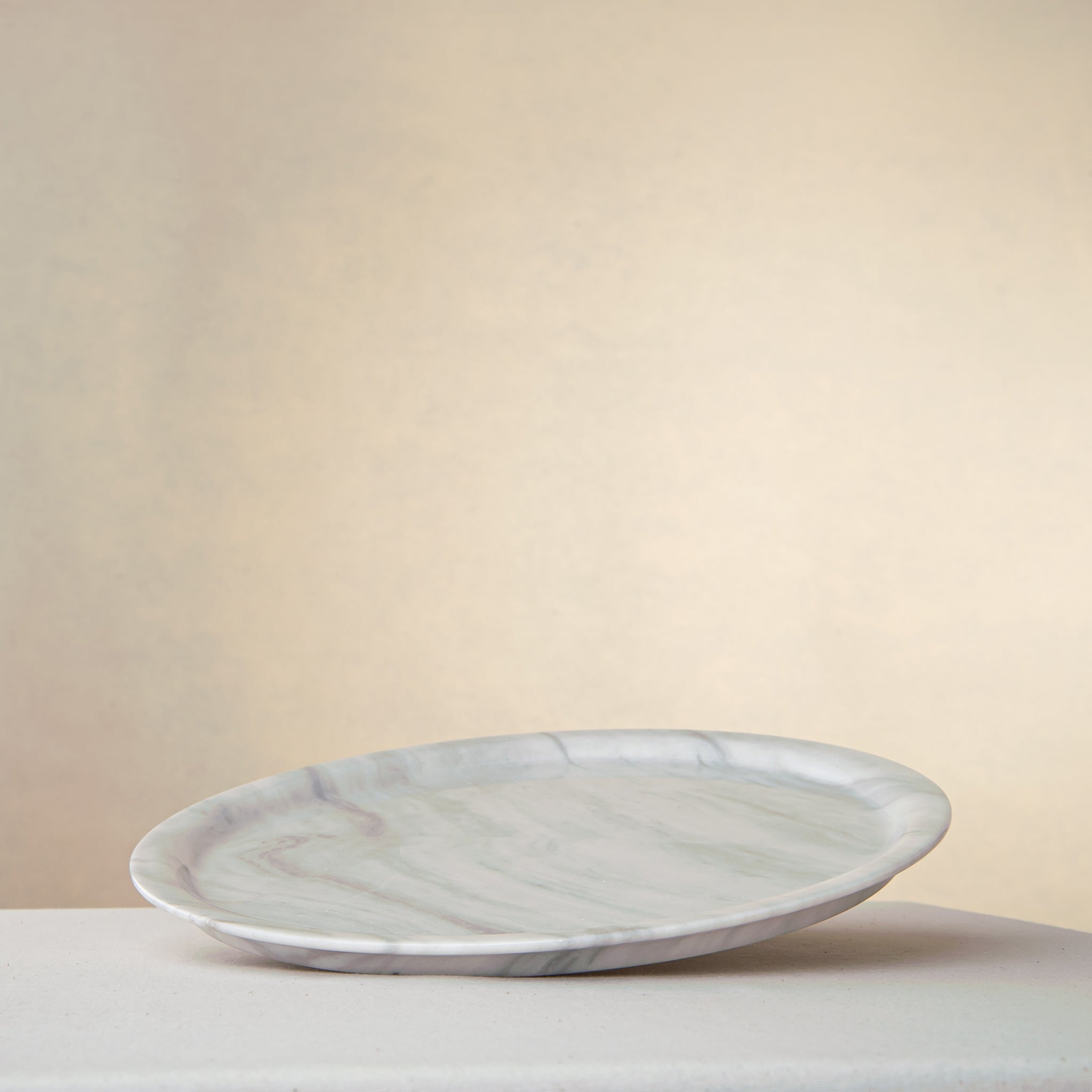 handcrafted marble plate with soft white surface and grey veining for elegant table decor

