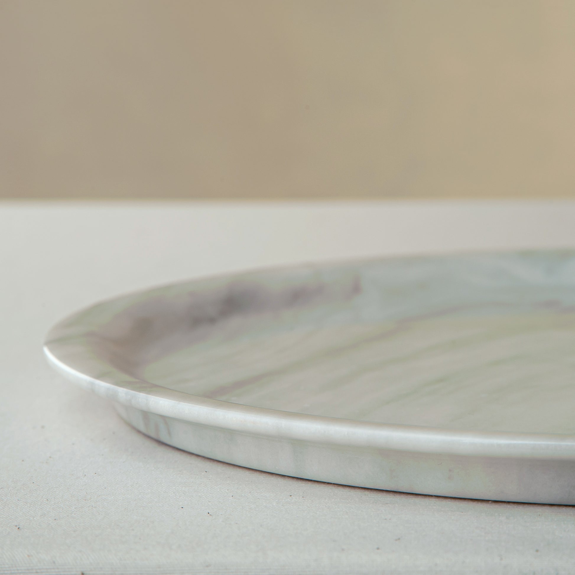 handcrafted marble plate with soft white surface and grey veining for elegant table decor
