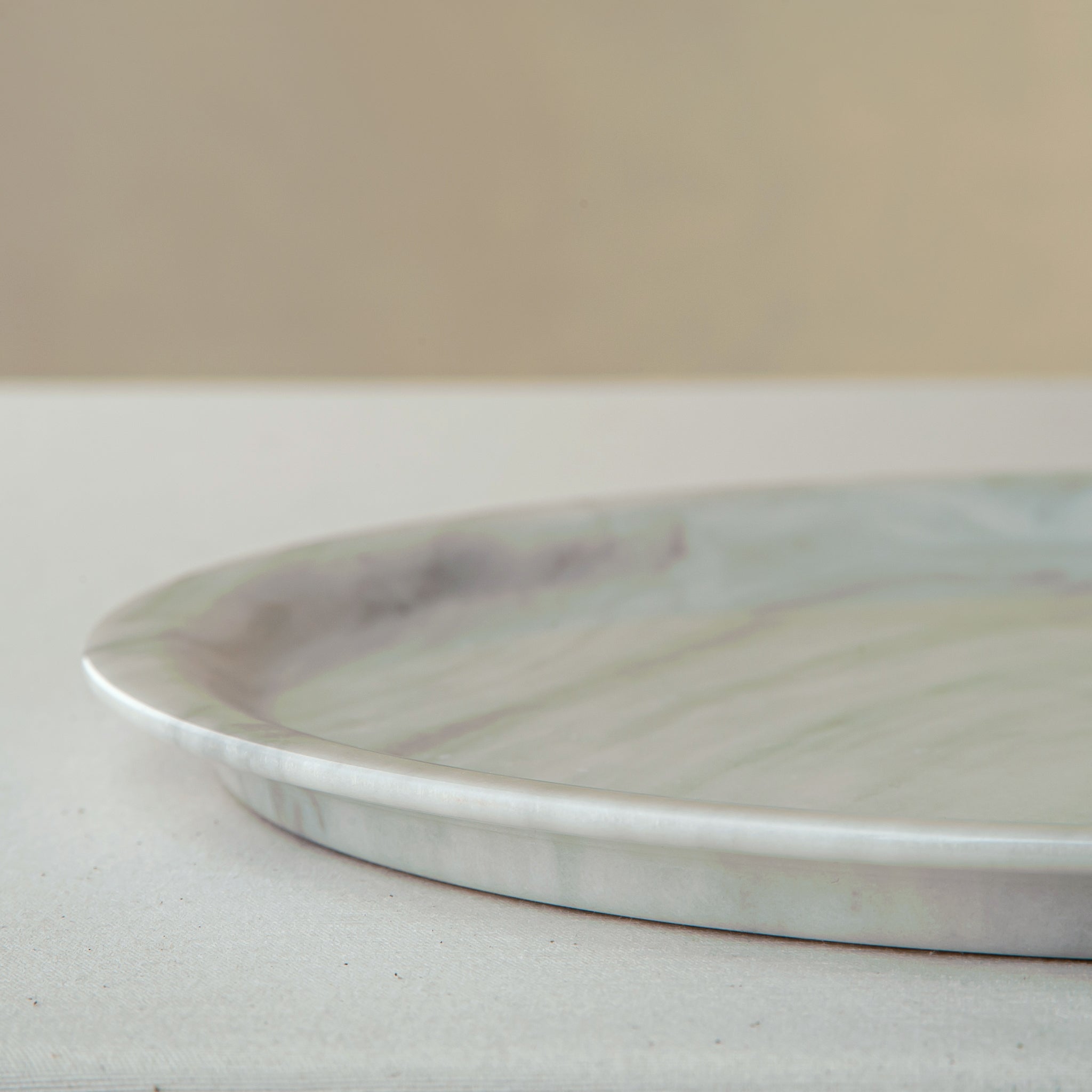 handcrafted marble plate with soft white surface and grey veining for elegant table decor
