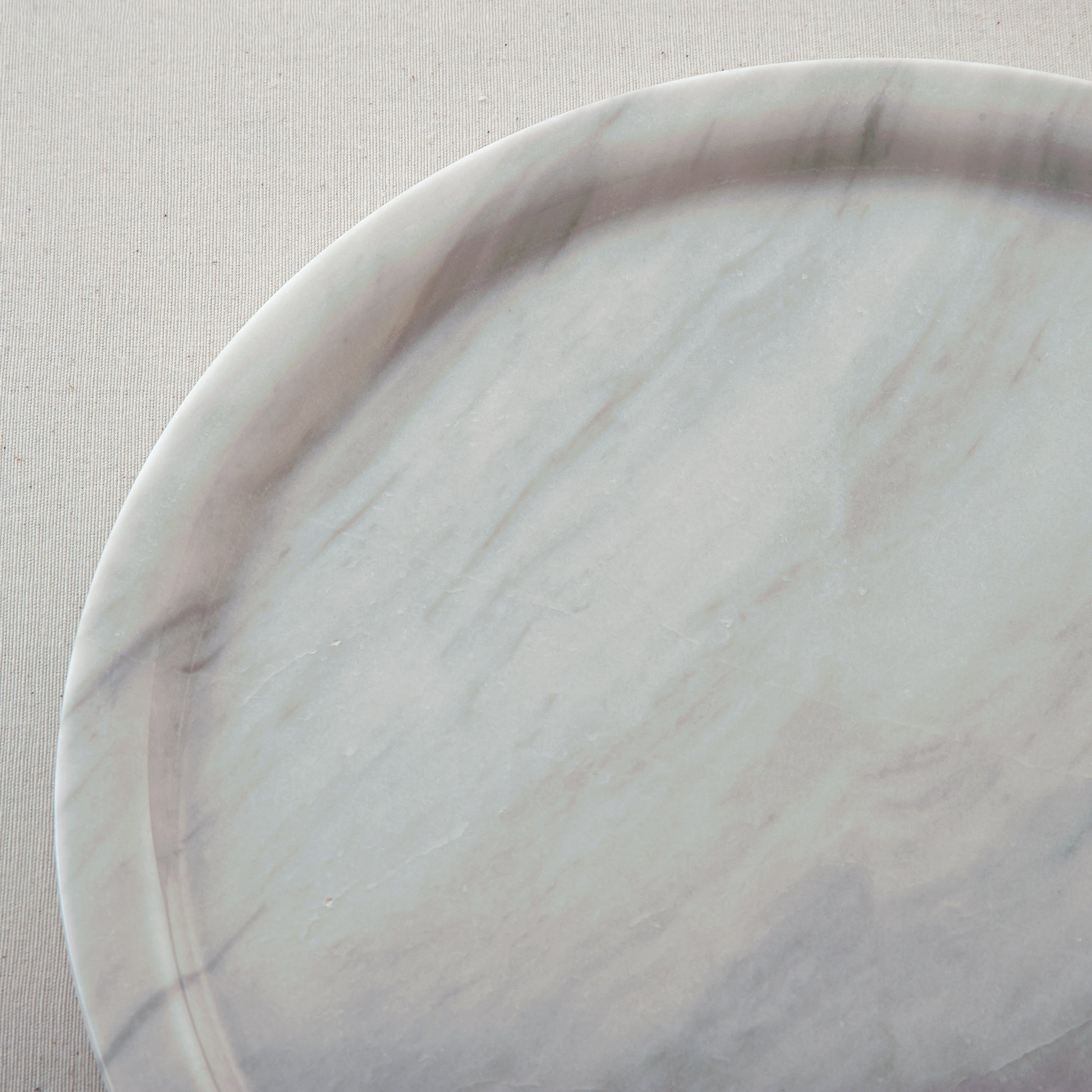 handcrafted marble plate with soft white surface and grey veining for elegant table decor
