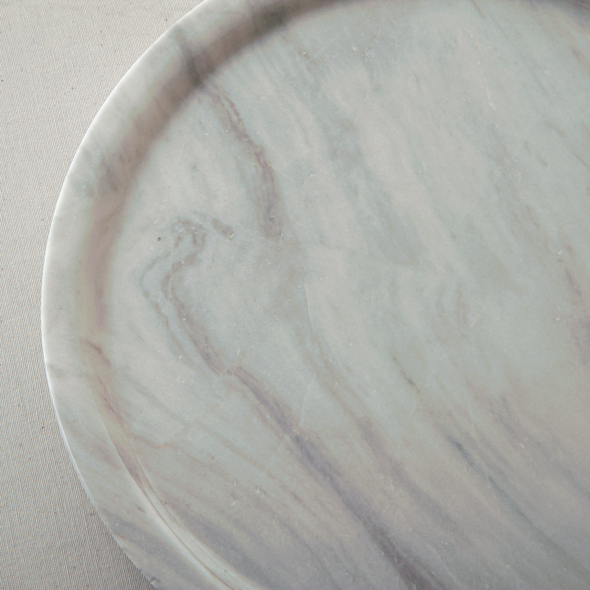 handcrafted marble plate with soft white surface and grey veining for elegant table decor

