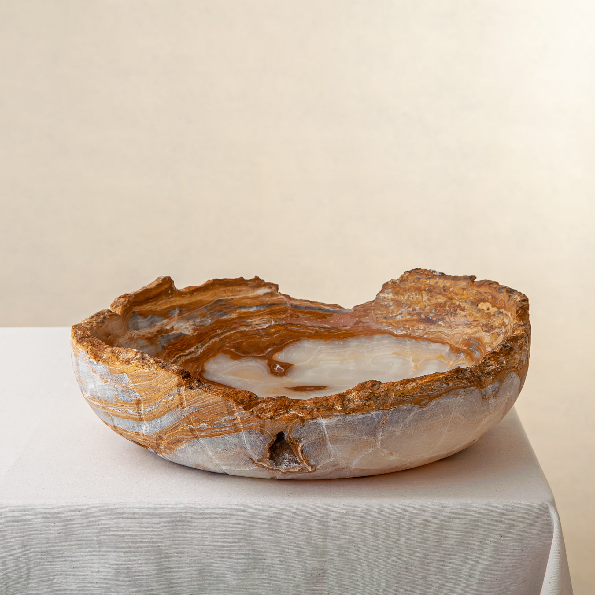 handcrafted onyx bowl with raw edge and amber rust veining for statement decor
