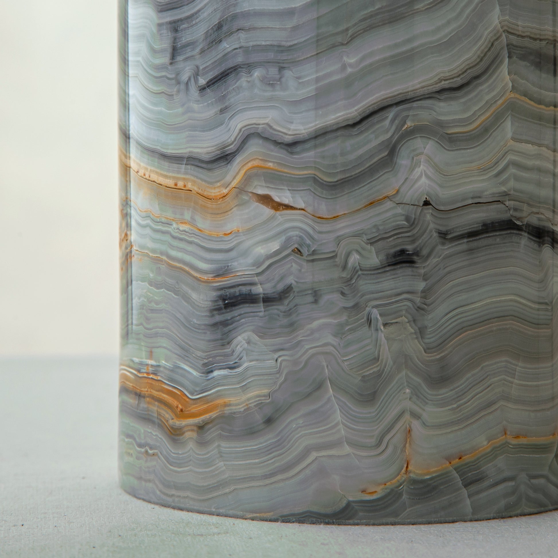 artisanal onyx vase with smooth polished surface and flowing veining patterns

