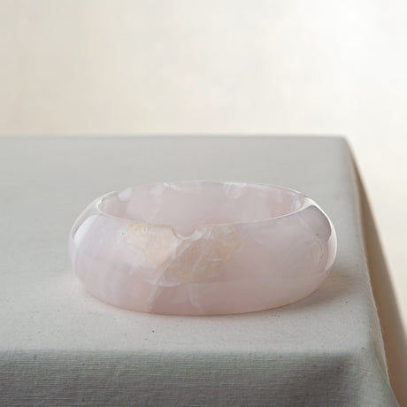Handcrafted rose onyx ash tray with soft pink tones and smooth sculptural form for elegant table decor

