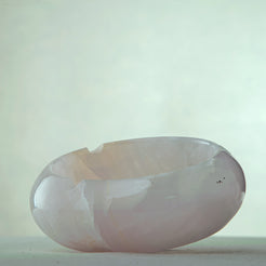 Handcrafted rose onyx ash tray with soft pink tones and smooth sculptural form for elegant table decor

