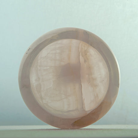 Handcrafted rose onyx ash tray with soft pink tones and smooth sculptural form for elegant table decor
