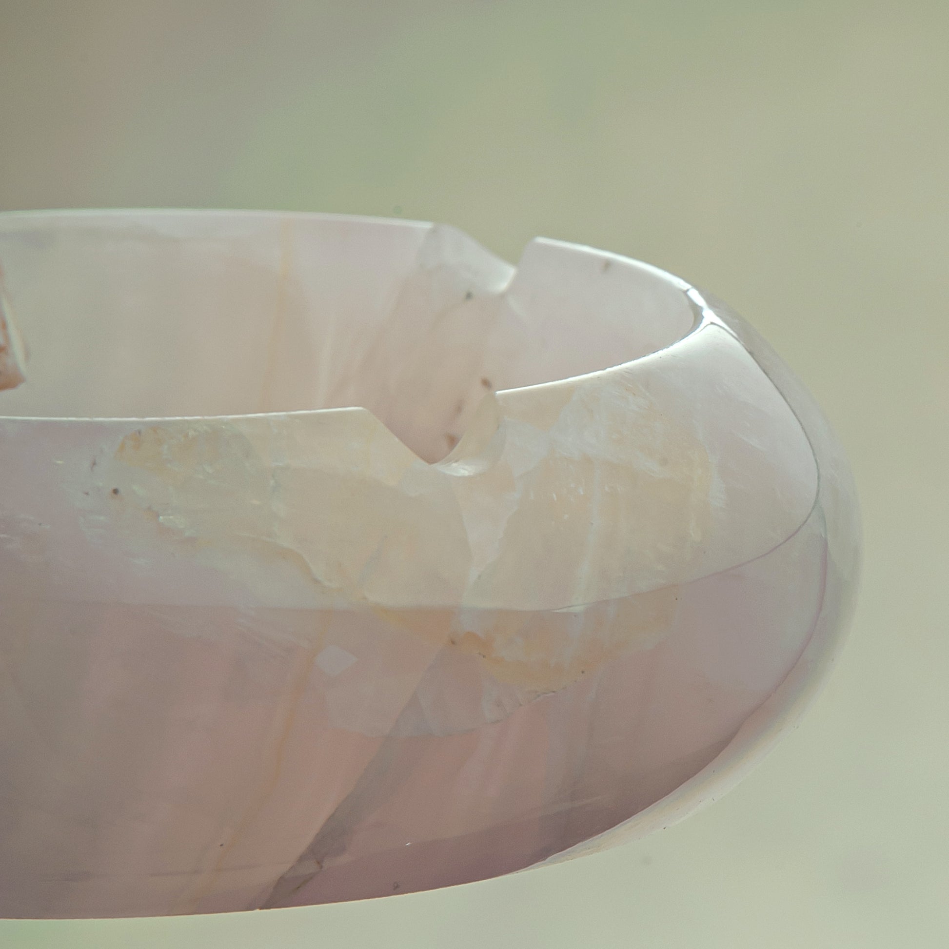 Handcrafted rose onyx ash tray with soft pink tones and smooth sculptural form for elegant table decor
