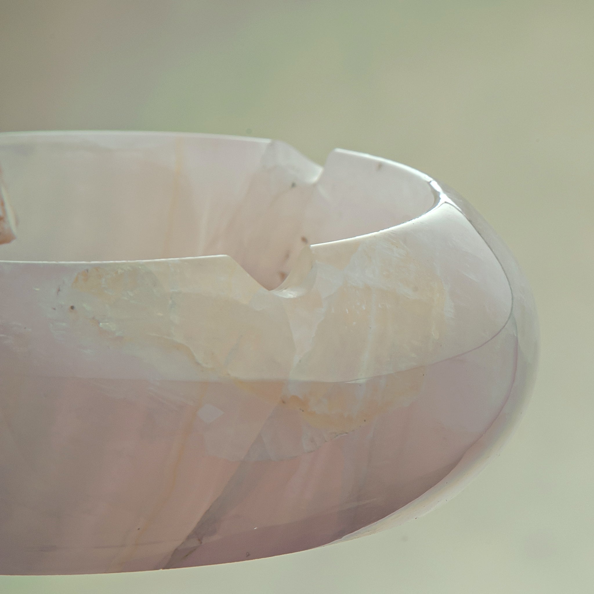 Handcrafted rose onyx ash tray with soft pink tones and smooth sculptural form for elegant table decor

