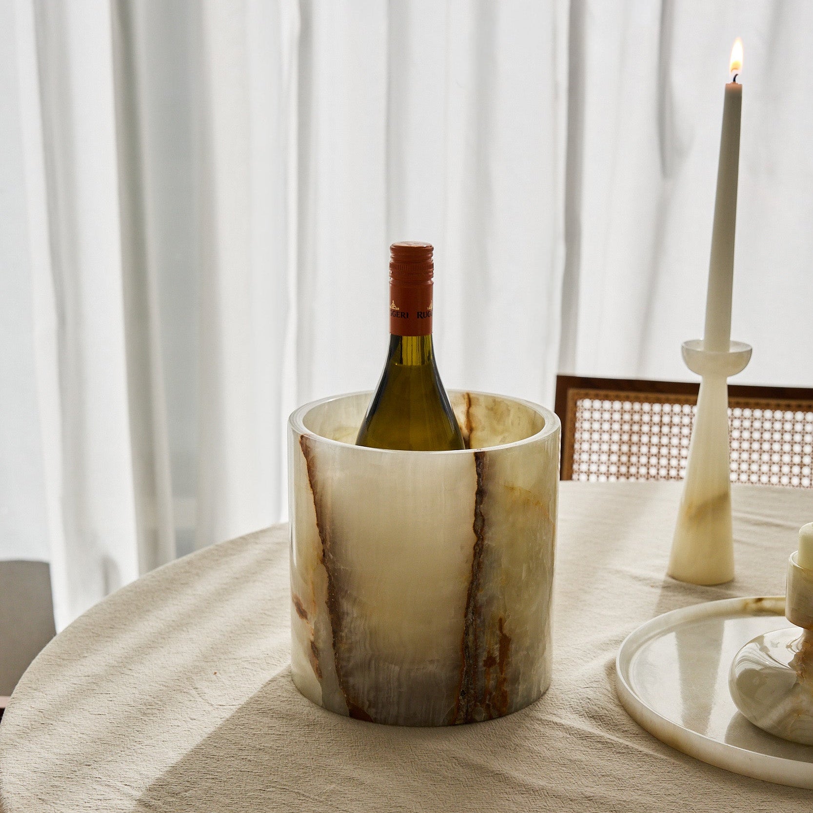 Unique onyx bottle cooler with luminous ivory stone and amber natural veining
