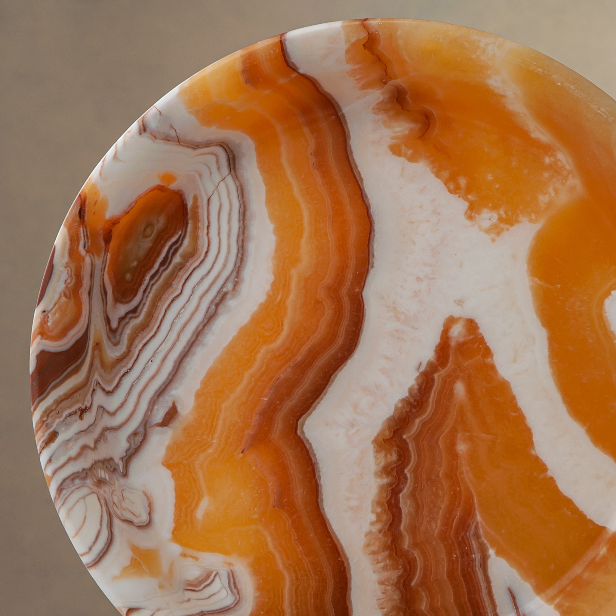 unique natural onyx bowl with warm honey coloration and sculptural pedestal as centerpiece
