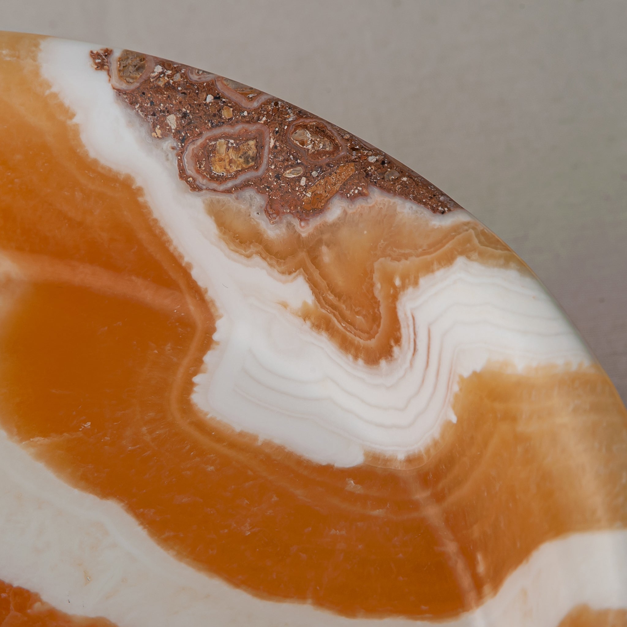 unique natural onyx bowl with warm honey coloration and sculptural pedestal as centerpiece
