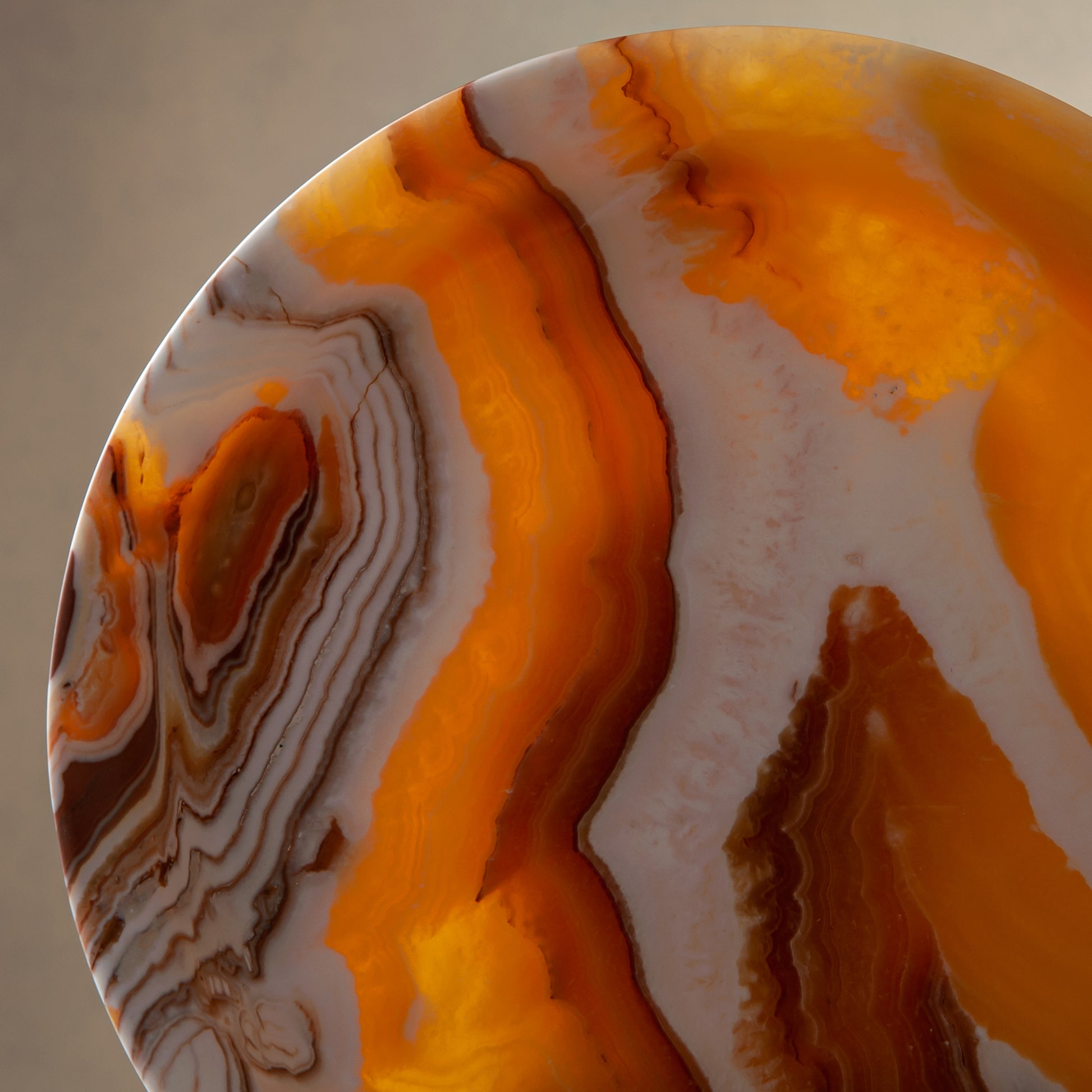 unique natural onyx bowl with warm honey coloration and sculptural pedestal as centerpiece
