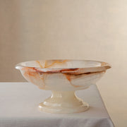 handcrafted onyx bowl with amber veining and translucent ivory stone on pedestal for luxury decor
