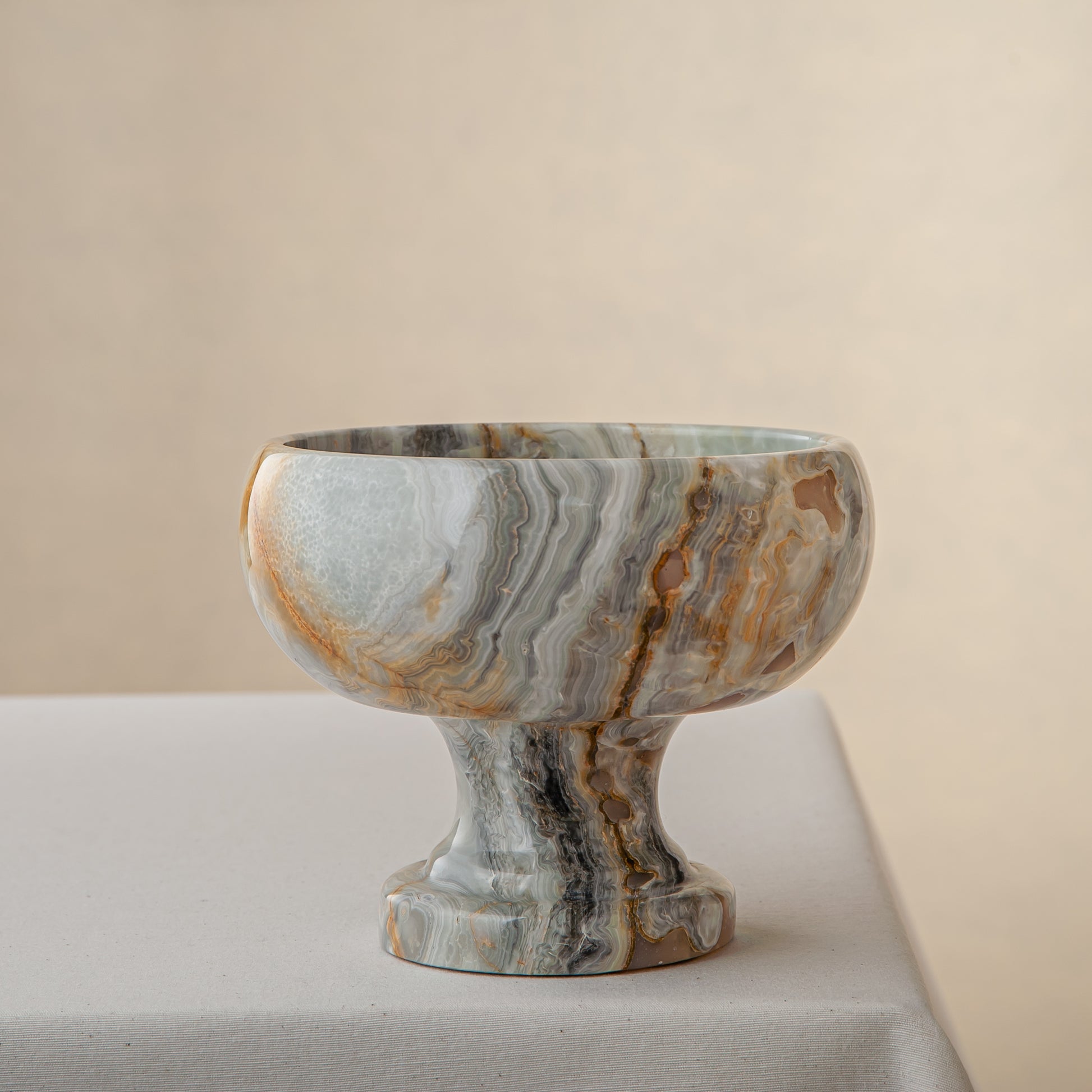 handcrafted onyx bowl with pedestal base and grey ivory banded patterns for luxury centerpiece
