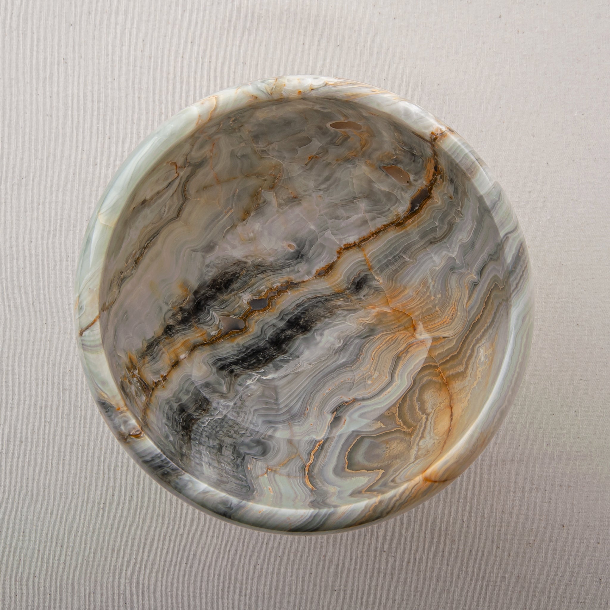 handcrafted onyx bowl with pedestal base and grey ivory banded patterns for luxury centerpiece
