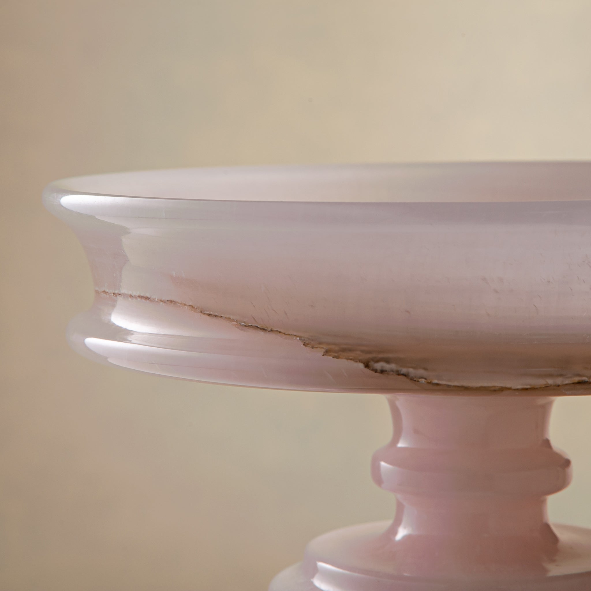 handcrafted onyx bowl with blush pink tones and translucent layered stone on pedestal for luxury decor
