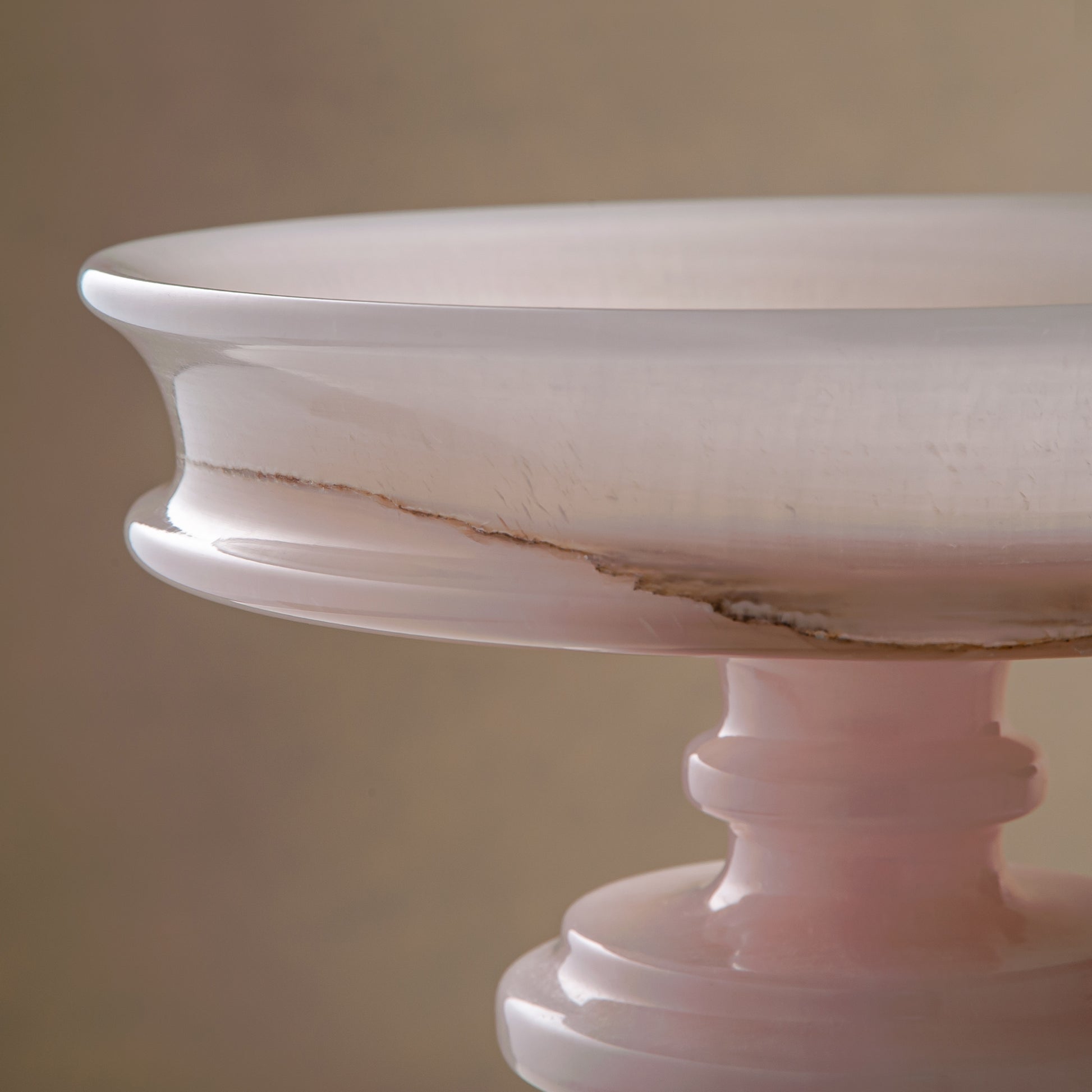 handcrafted onyx bowl with blush pink tones and translucent layered stone on pedestal for luxury decor
