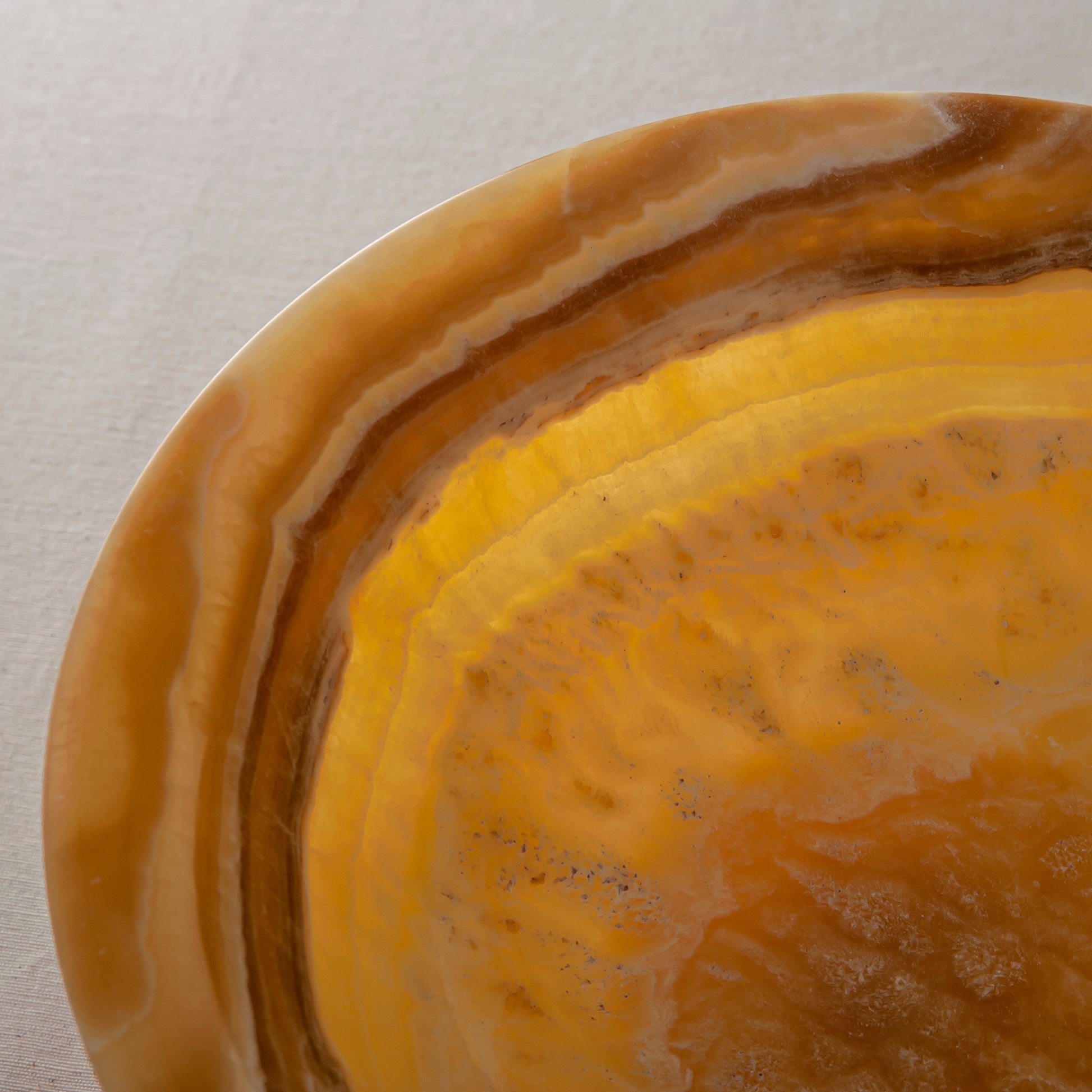handcrafted onyx bowl with golden tones and caramel veining for luxury table decor
