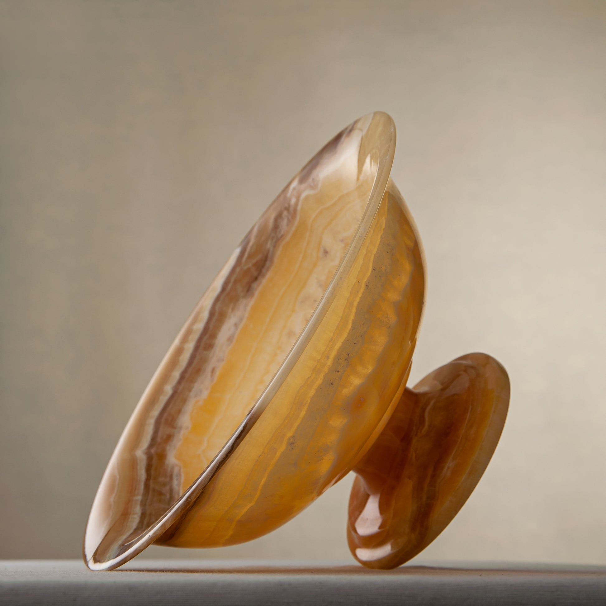 handcrafted onyx bowl with golden tones and caramel veining for luxury table decor
