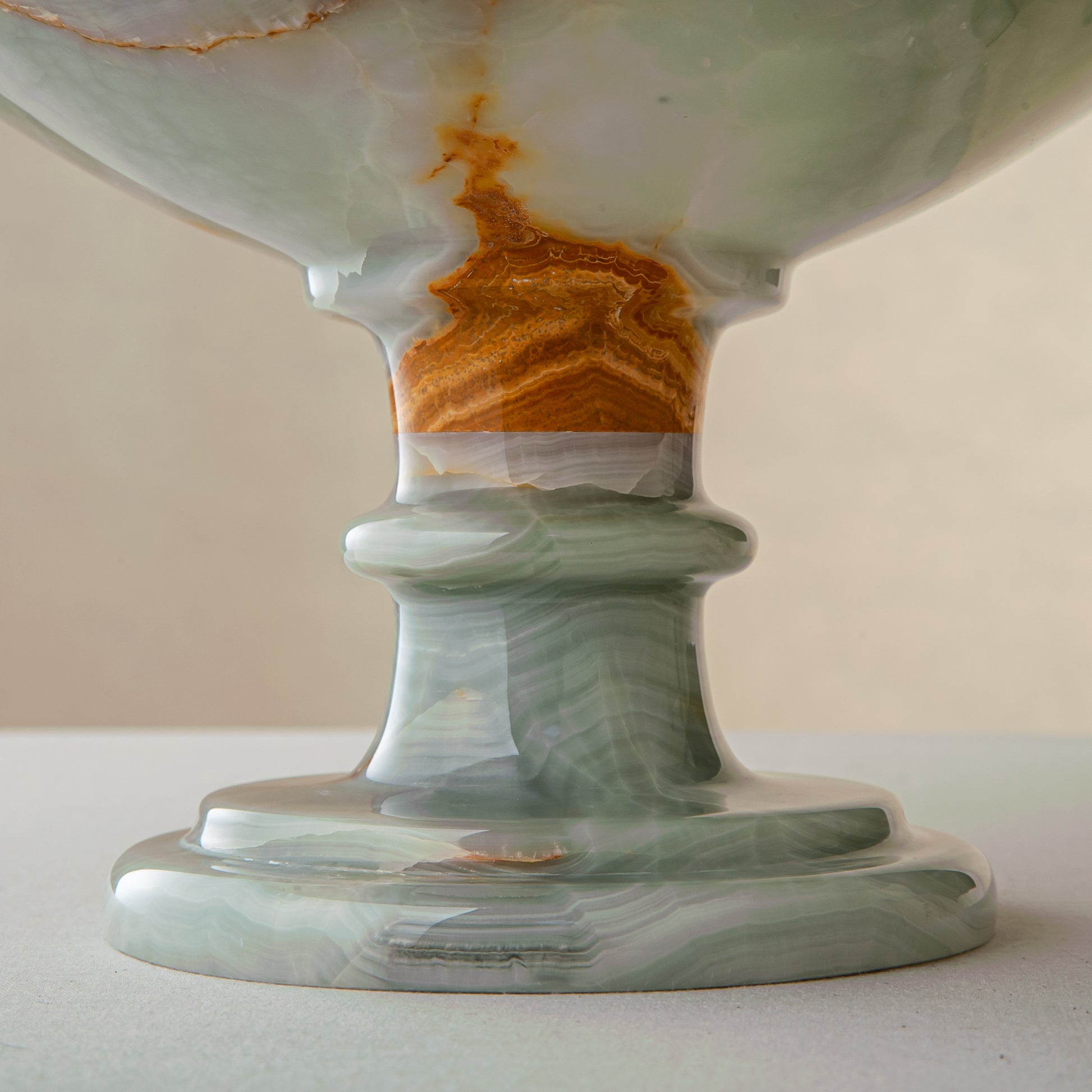 handcrafted green onyx bowl with amber veining and translucent surface for luxury decor
