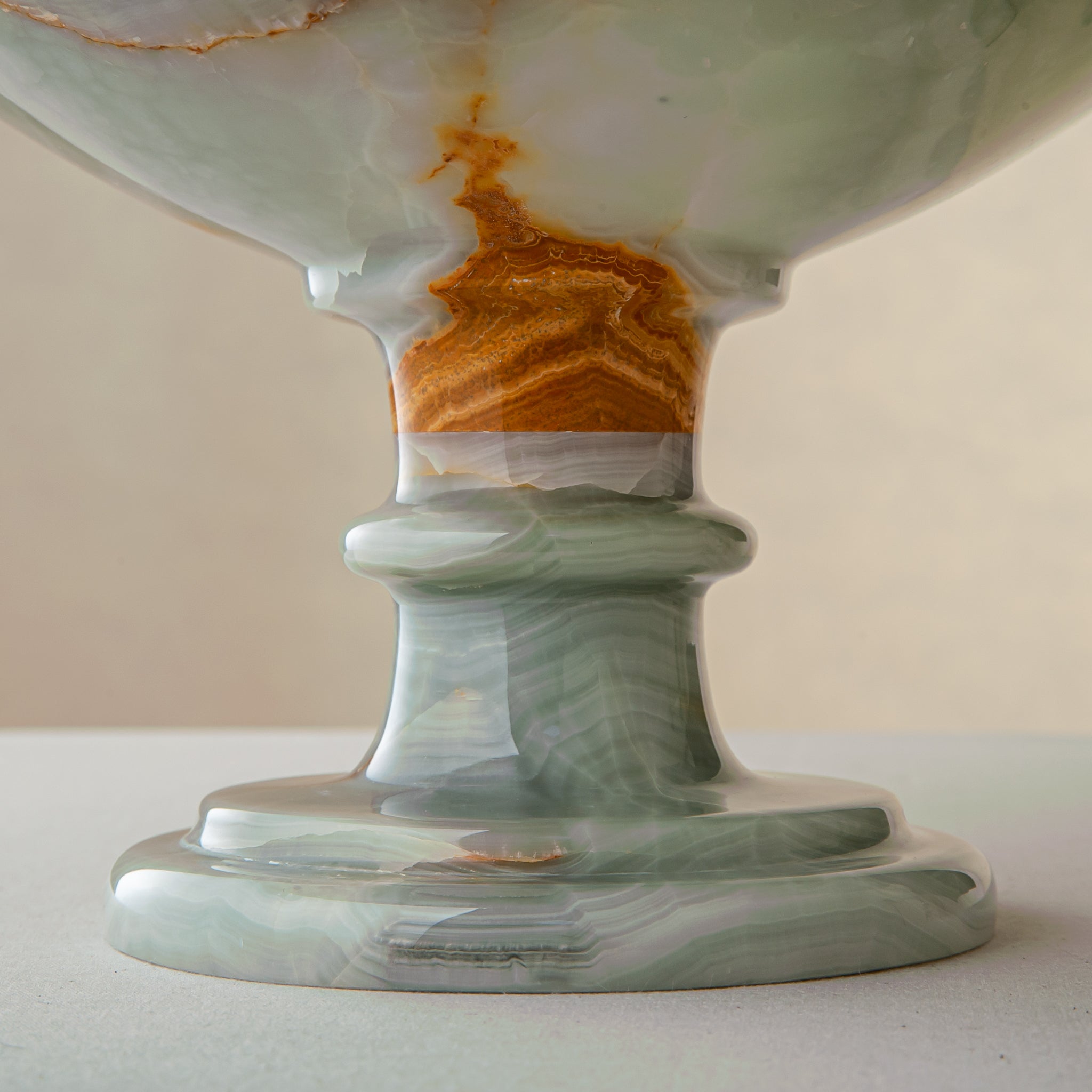 handcrafted green onyx bowl with amber veining and translucent surface for luxury decor
